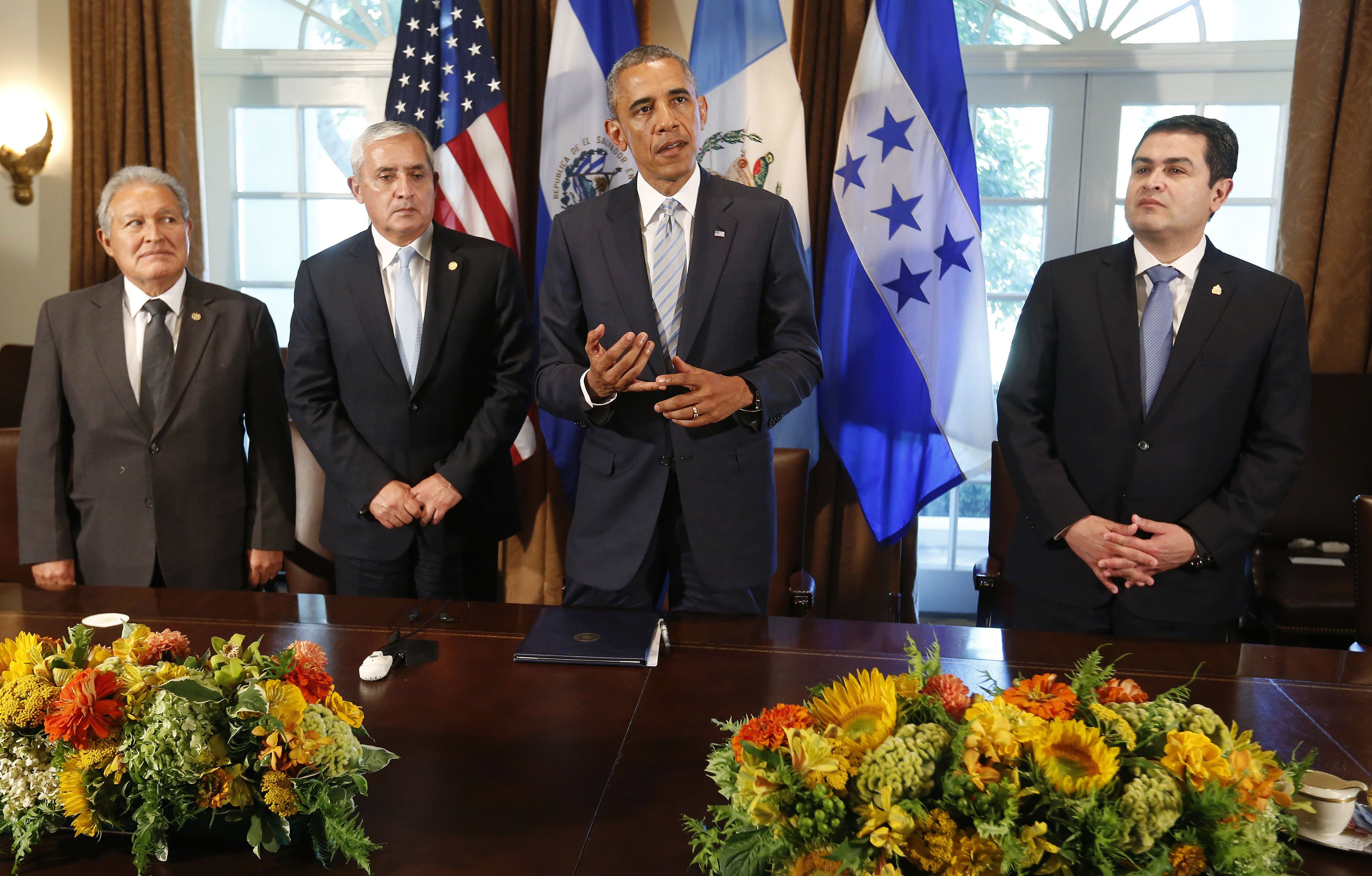 U.S. President Obama speaks to the media while he hosts a meeting with El Salvador's President Sanchez Ceren, Guatemala's President Perez Molina and Honduras' President Orlando Hernandez in the Cabinet Room of the White House in Washington