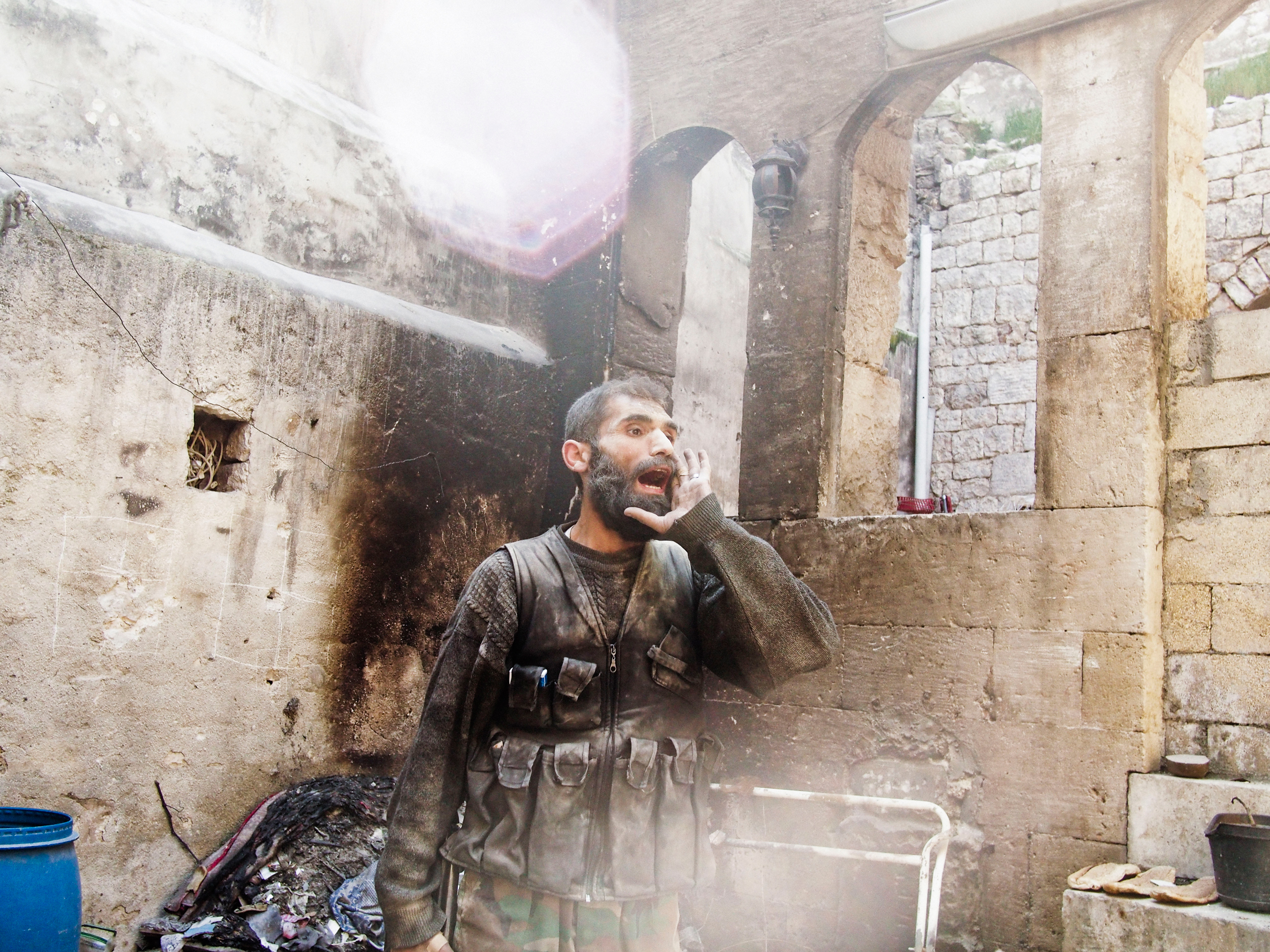 A rebel fighter in Aleppo, Syria yells "Allah u Akhbar" after the sound of an explosion could be heard close-by during fighting in Old City on March 26, 2013. 