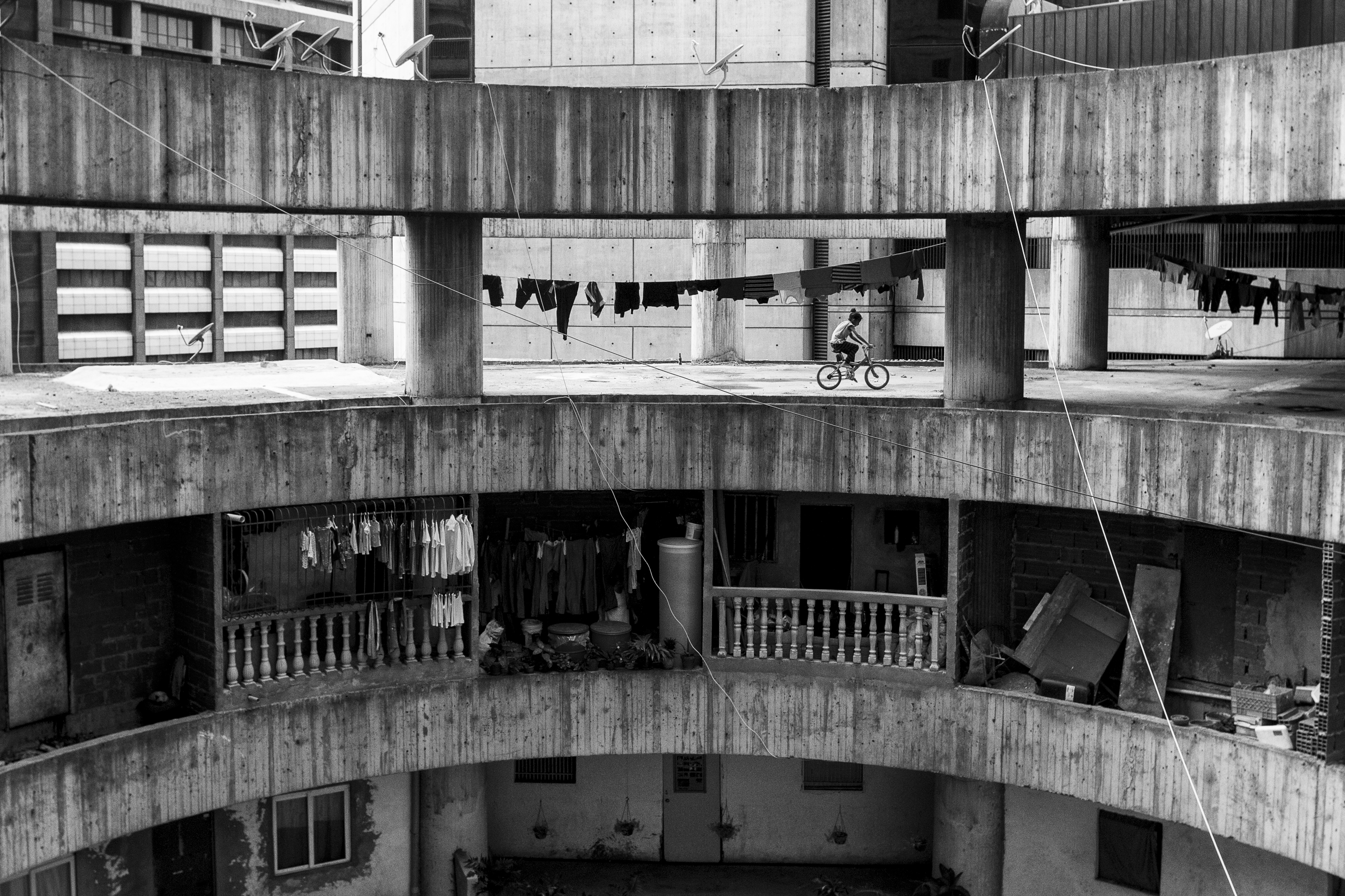 A girl cycles in the tower, running the risk of falling into the void