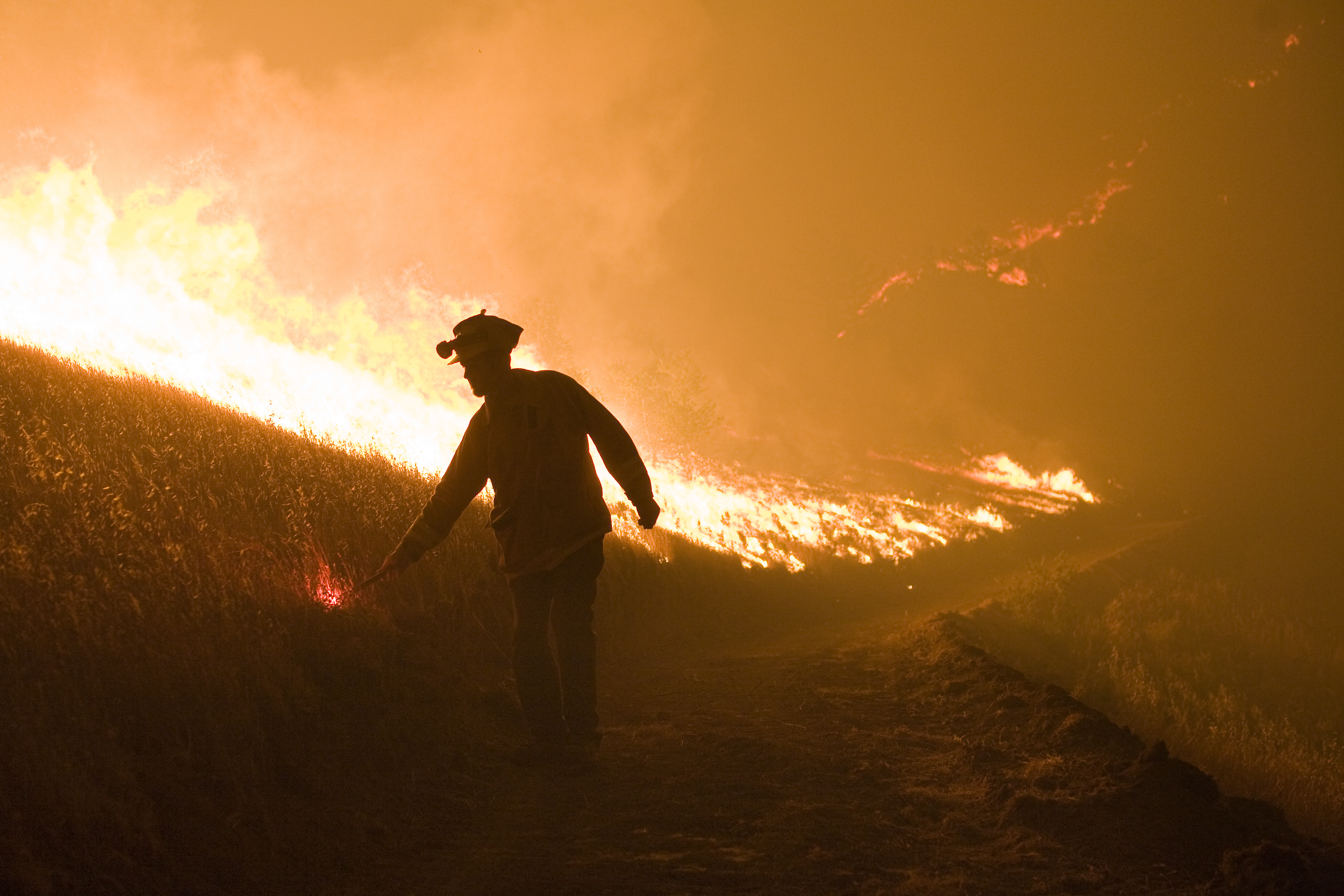 Firefighter fights a wildfire with a backfire in Big Sur, California