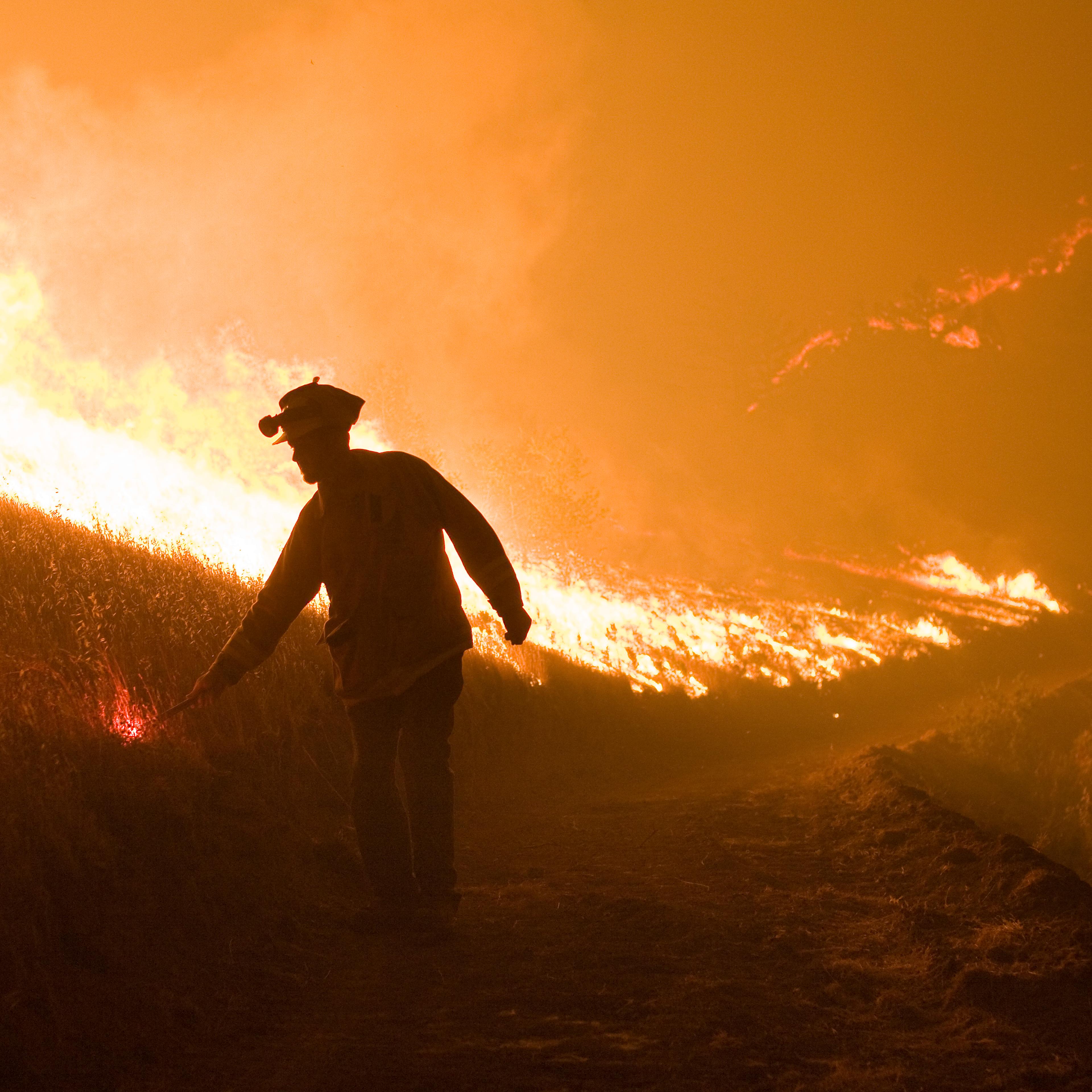 Firefighter fights a wildfire with a backfire in Big Sur, California