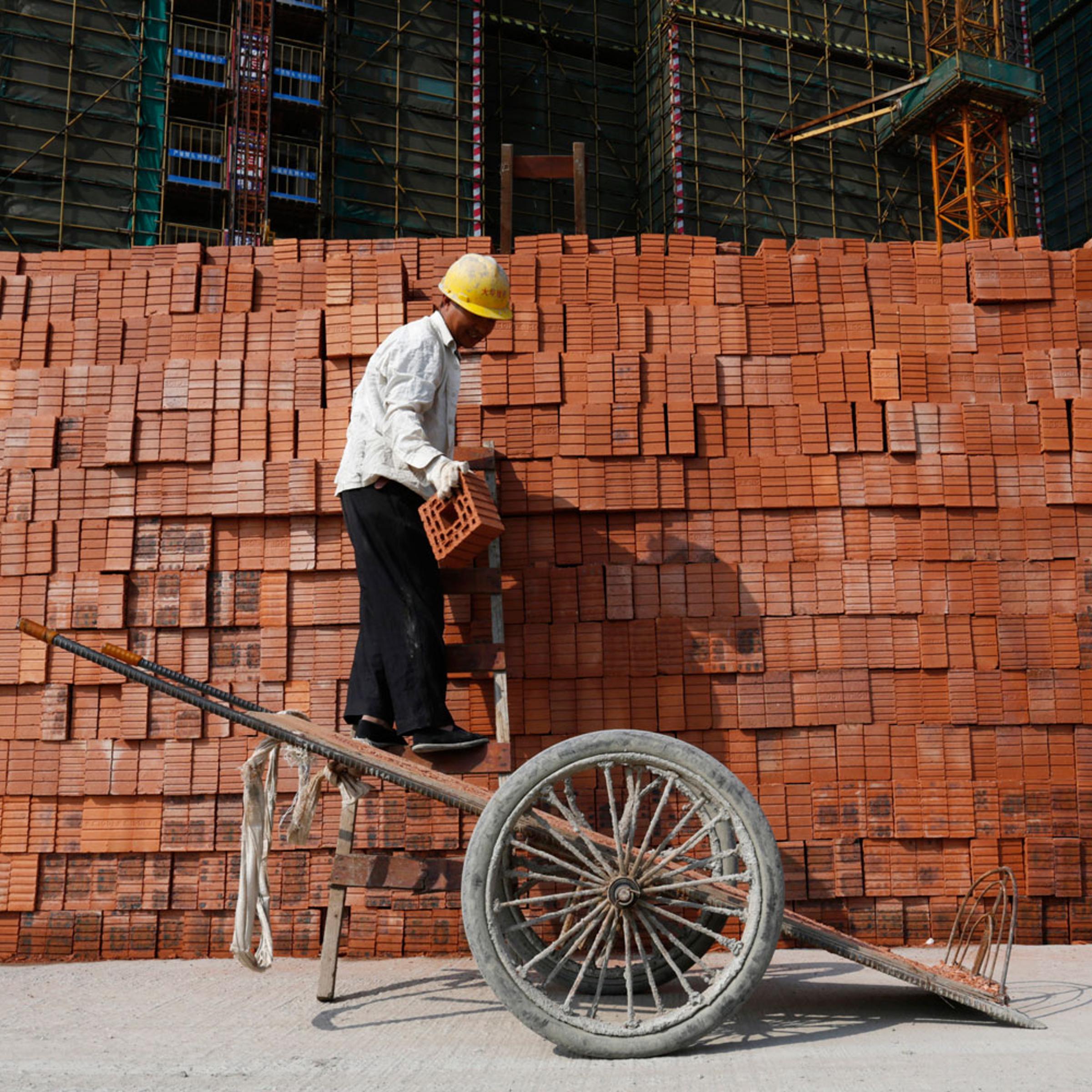 A labourer works at a construction site in Hangzhou, Zhejiang province, April 14, 2014. China's economy grew at its slowest pace in 18 months in the first quarter of 2014, official data showed on Wednesday.