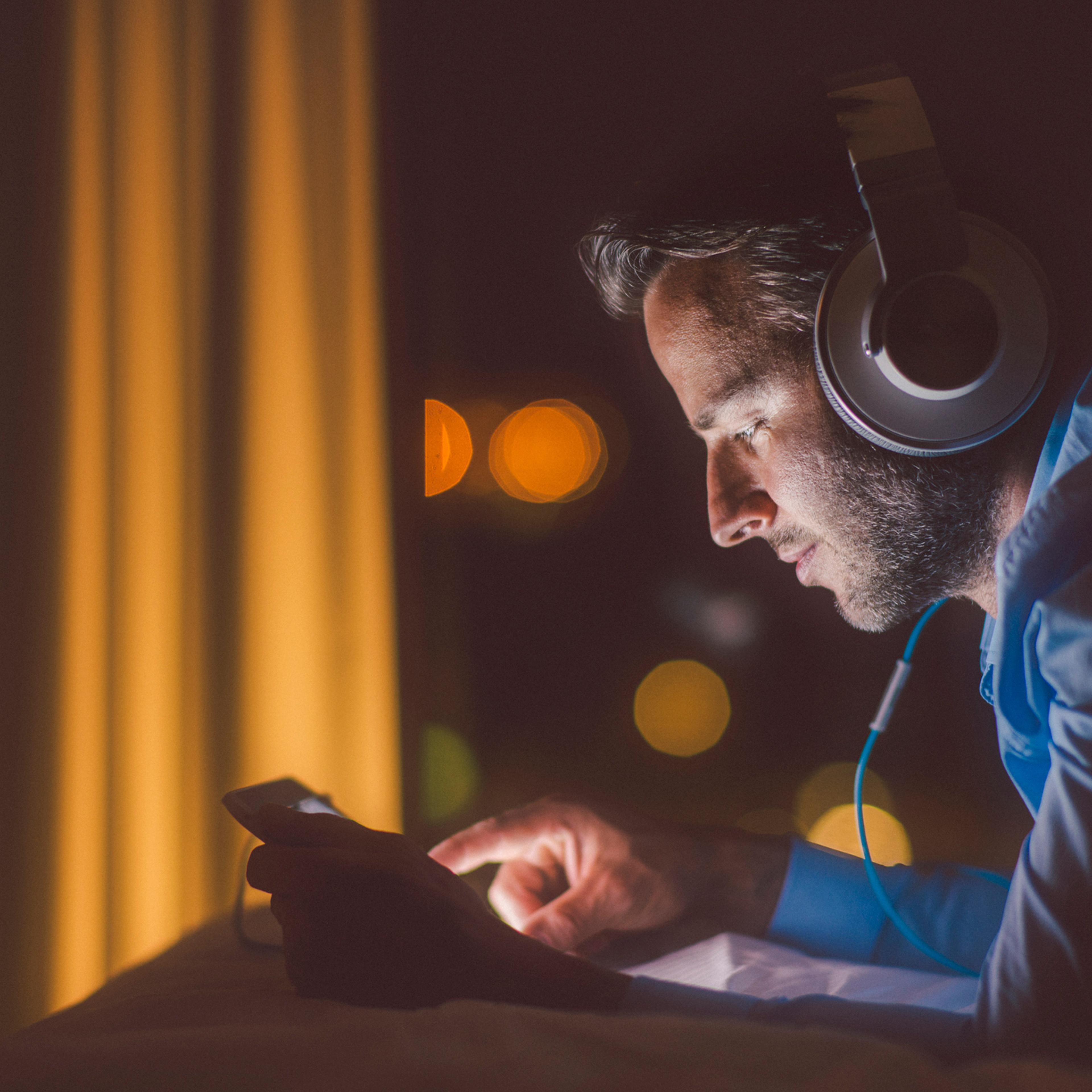 Man using tablet pc in evening.