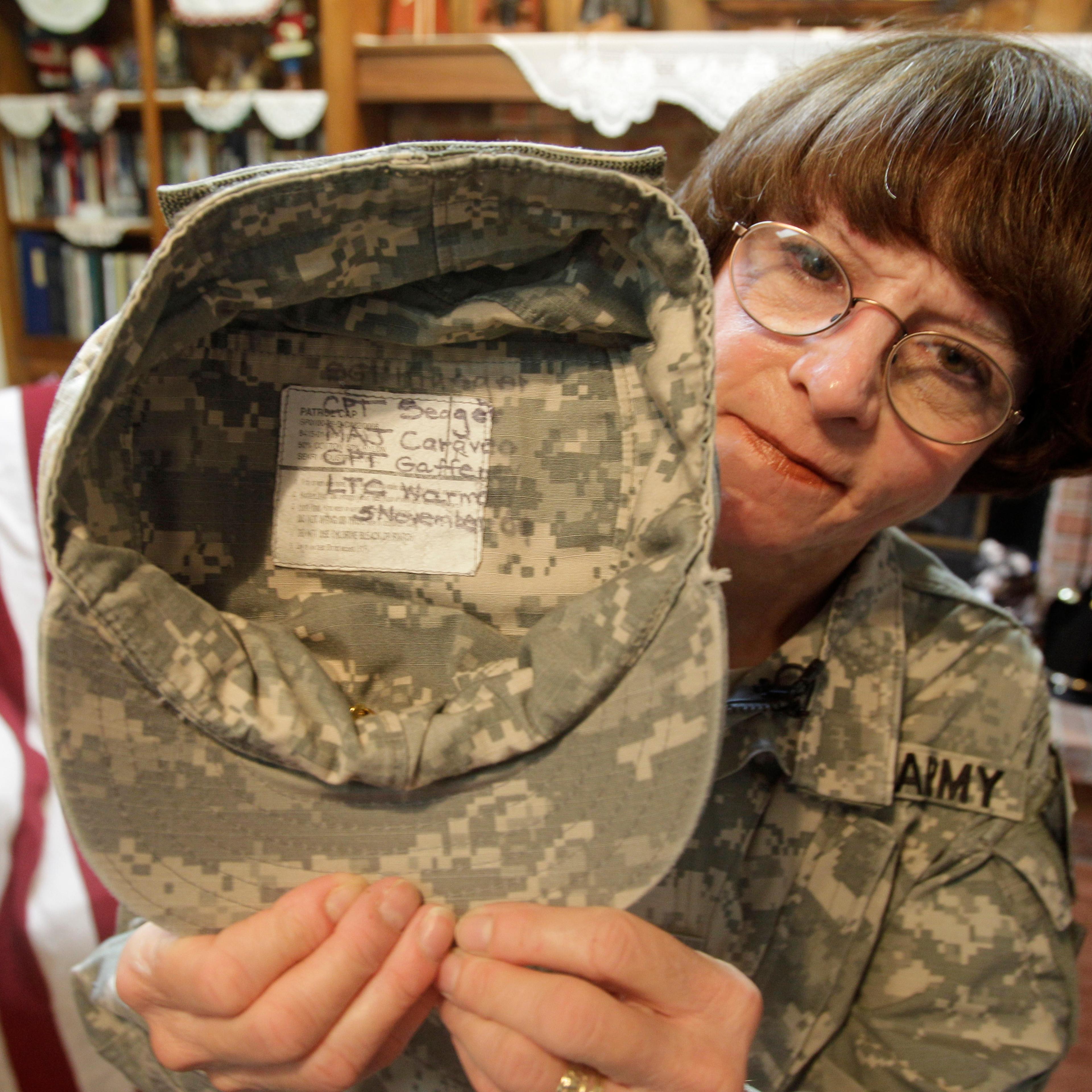 U.S. Army Col. Kathy Platoni holds up her cap at her home in Beaver Creek, Ohio, Nov. 1, 2010.
