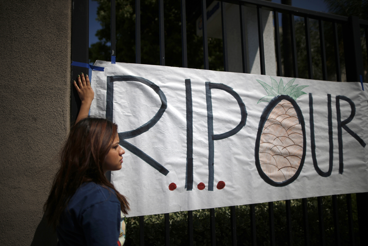 Students put up a sign for El Monte High School student Adrian Castro, outside the school in El Monte