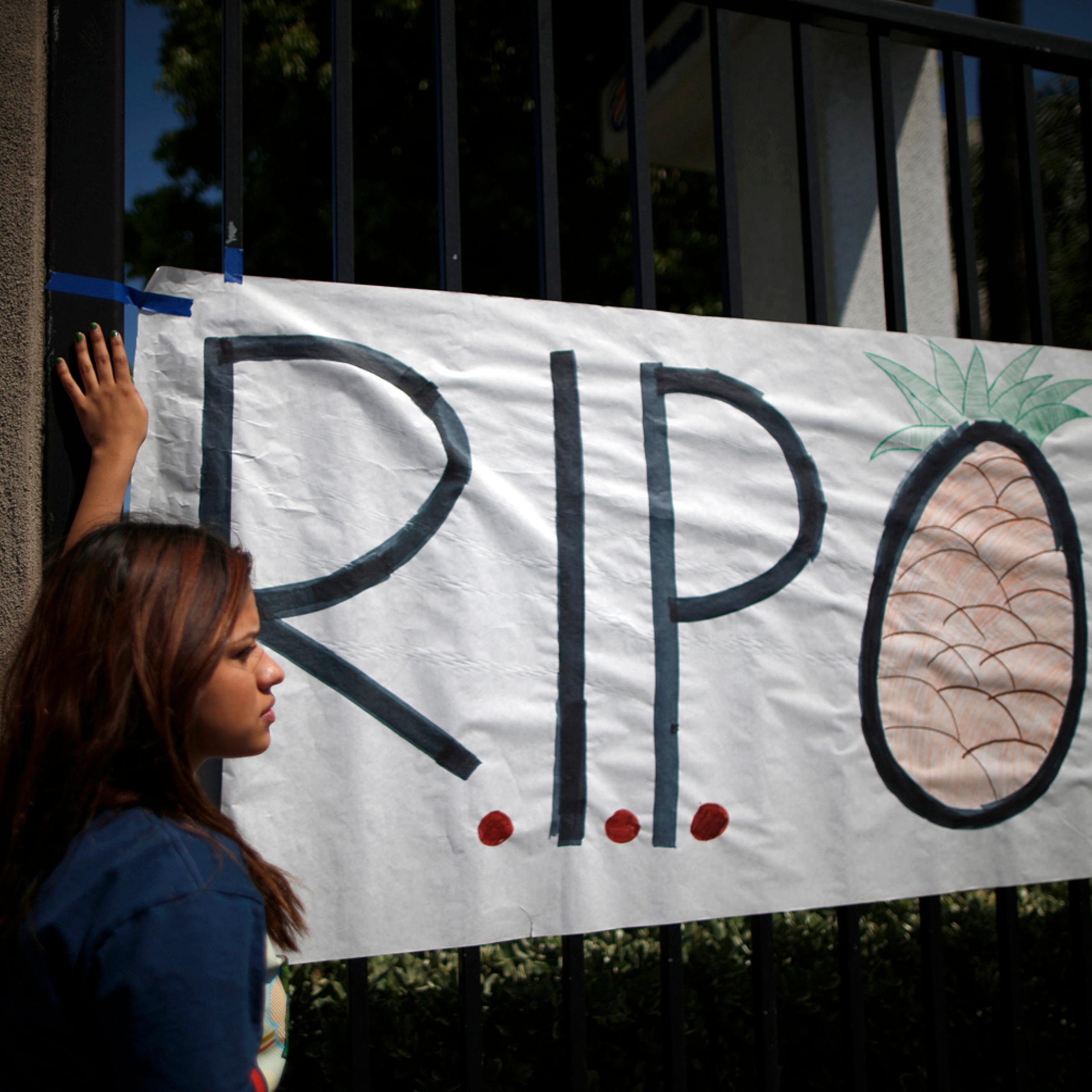 Students put up a sign for El Monte High School student Adrian Castro, outside the school in El Monte