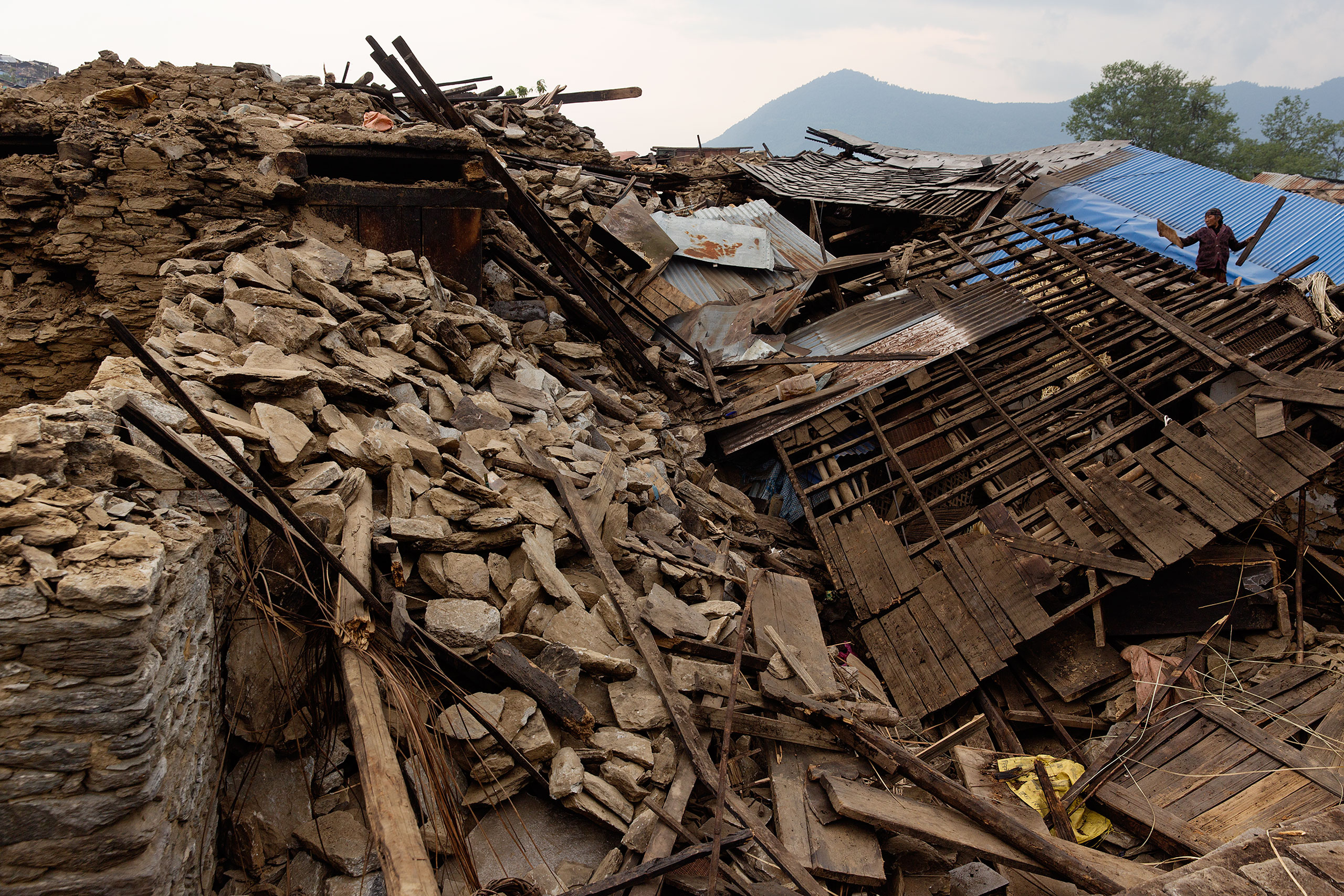 Nepal earthquake. Barpak, the epicenter of the earthquake. Funeral of Pur Bahadur Gurung, 26, who had just been dug out of the rubble. Saainli Gurung, his mother weeping. Scenes of villagers salvaging building materials and personal possessions. Dhan Raj
