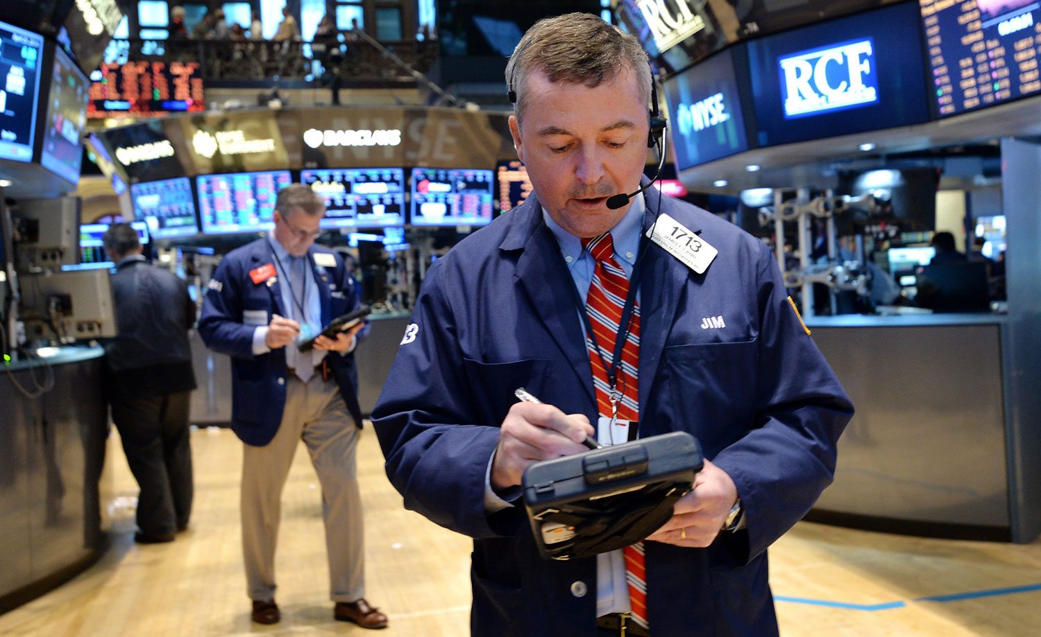 A trader works on the floor of the New York Stock Exchange at the end of the trading day in New York, April 25, 2014.