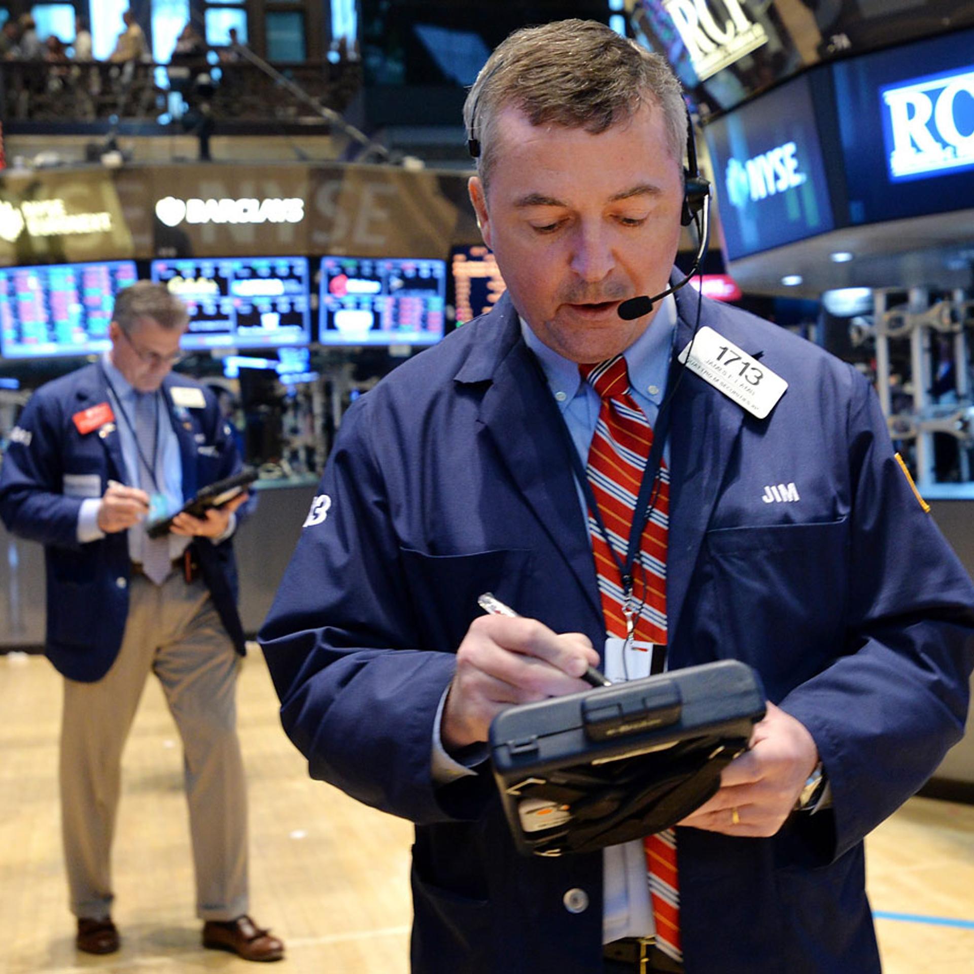 A trader works on the floor of the New York Stock Exchange at the end of the trading day in New York, April 25, 2014.