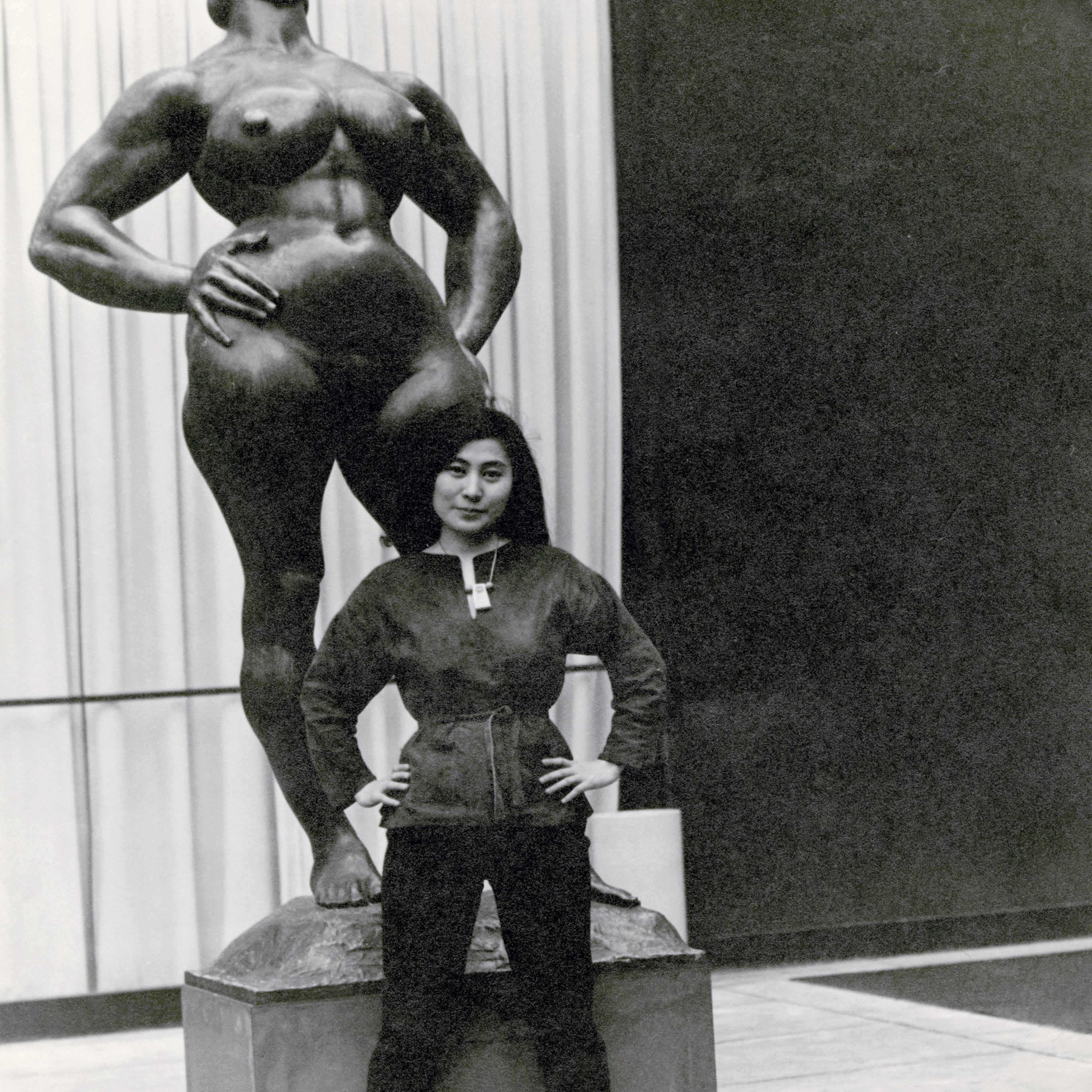 Yoko Ono with Standing Woman (1932) by Gaston Lachaise, The Museum of Modern Art Sculpture Garden, New York. c. 1960–61.