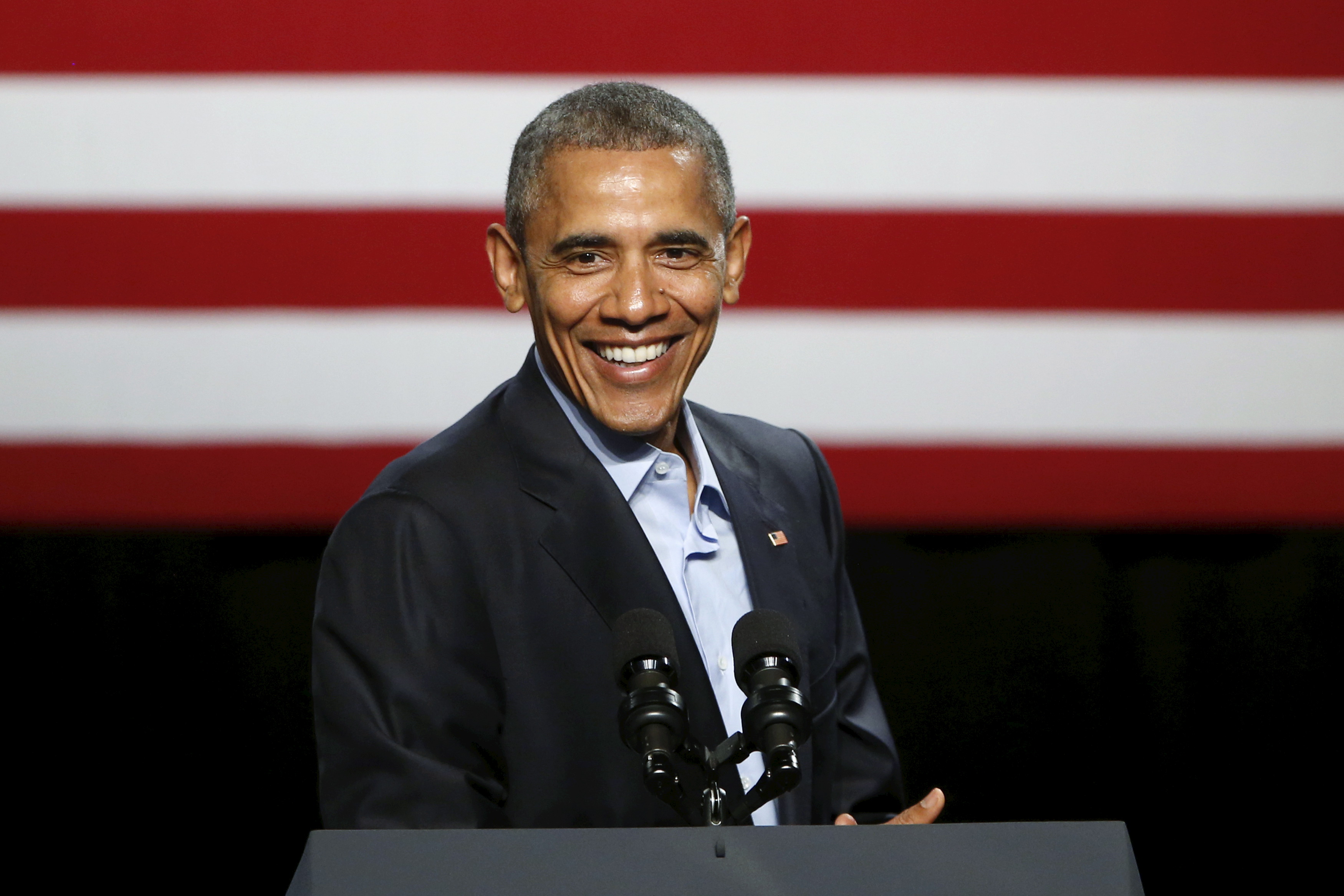 U.S. President Barack Obama laughs while he delivers remarks to supporters at a Democratic National Committee (DNC) event at Gilley's Club in Dallas, Texas on March 12, 2016.