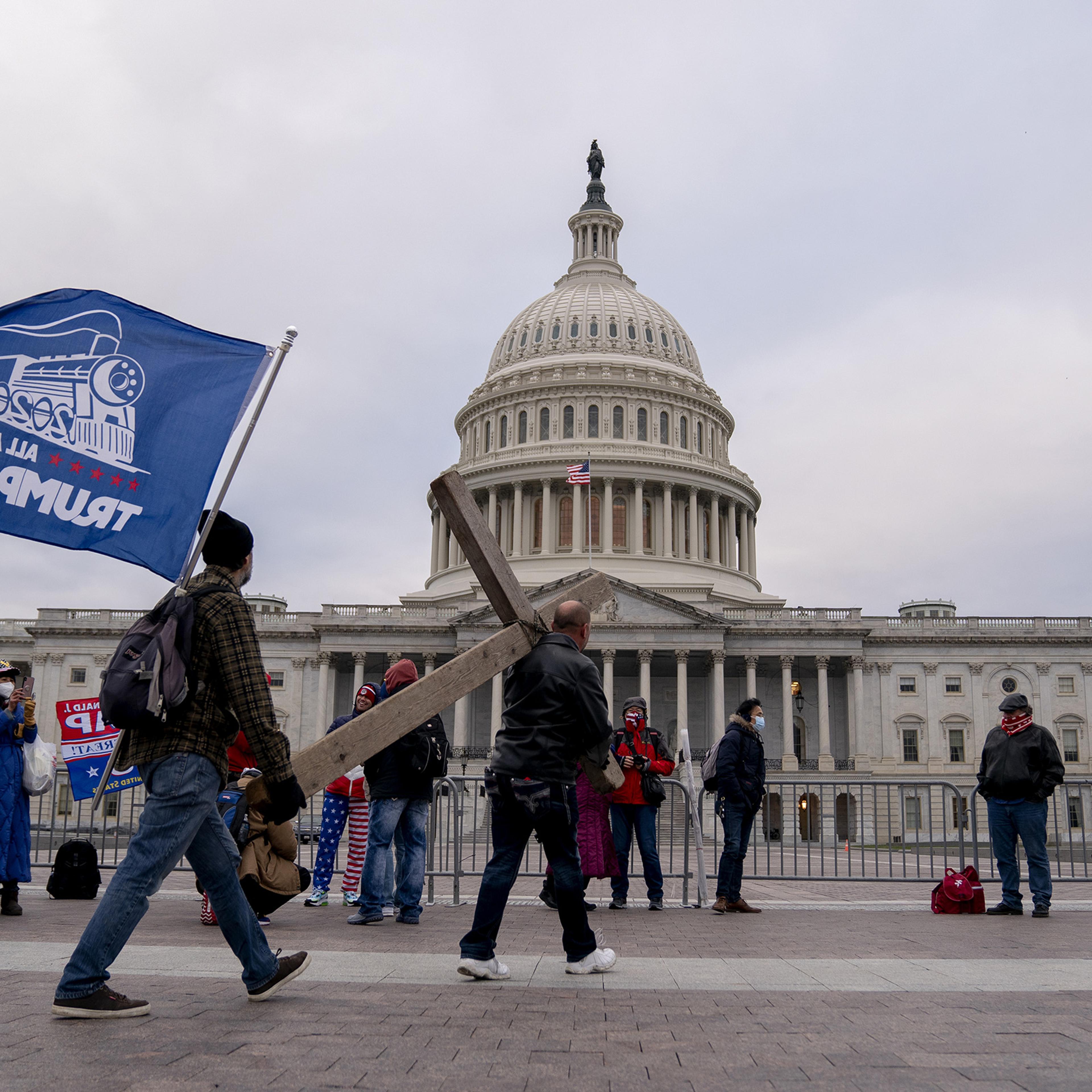 Demonstrators carry a cross to the U.S. Capitol on Jan. 6.