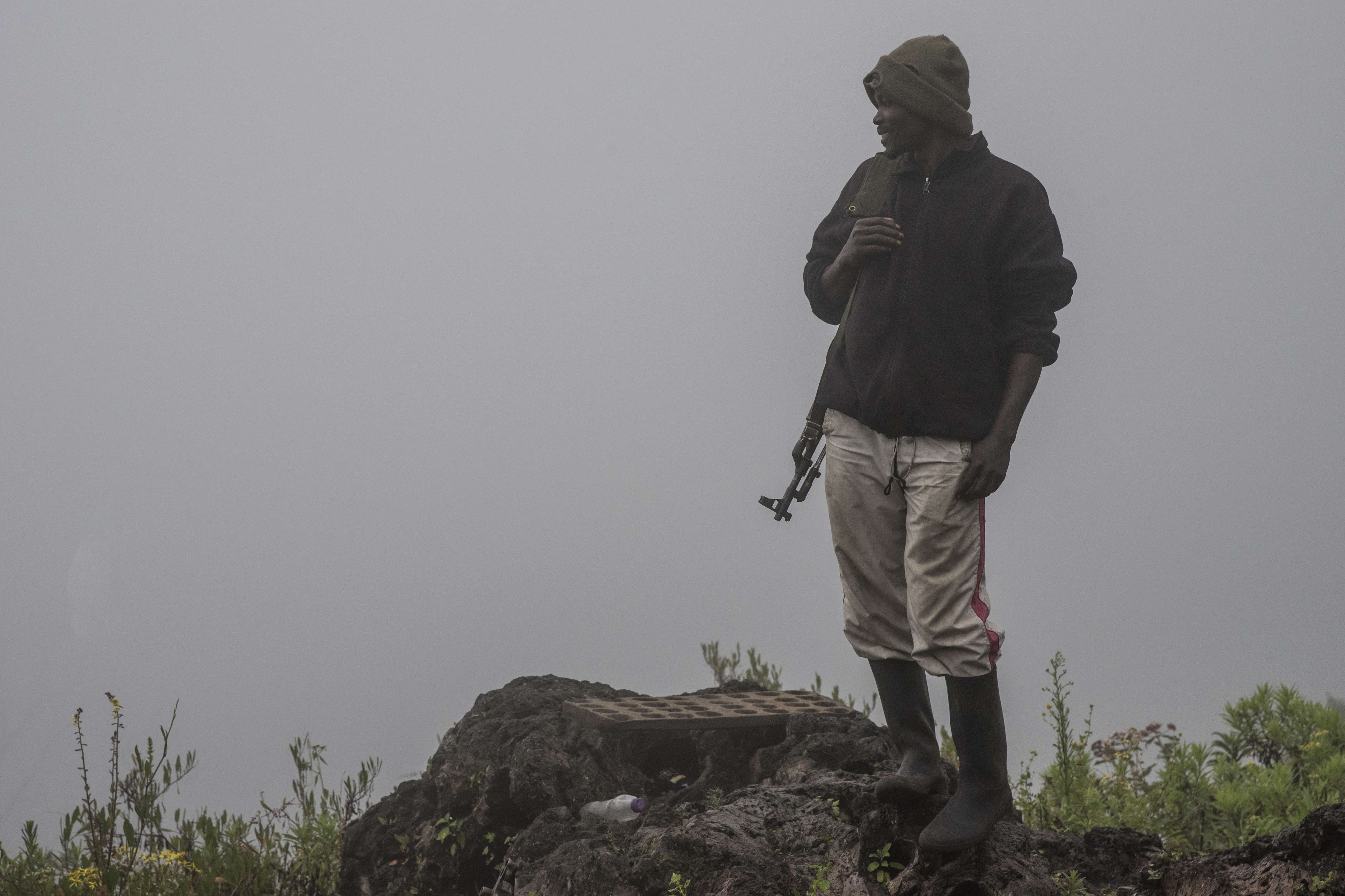 A ranger in the morning mist stands near a security post on