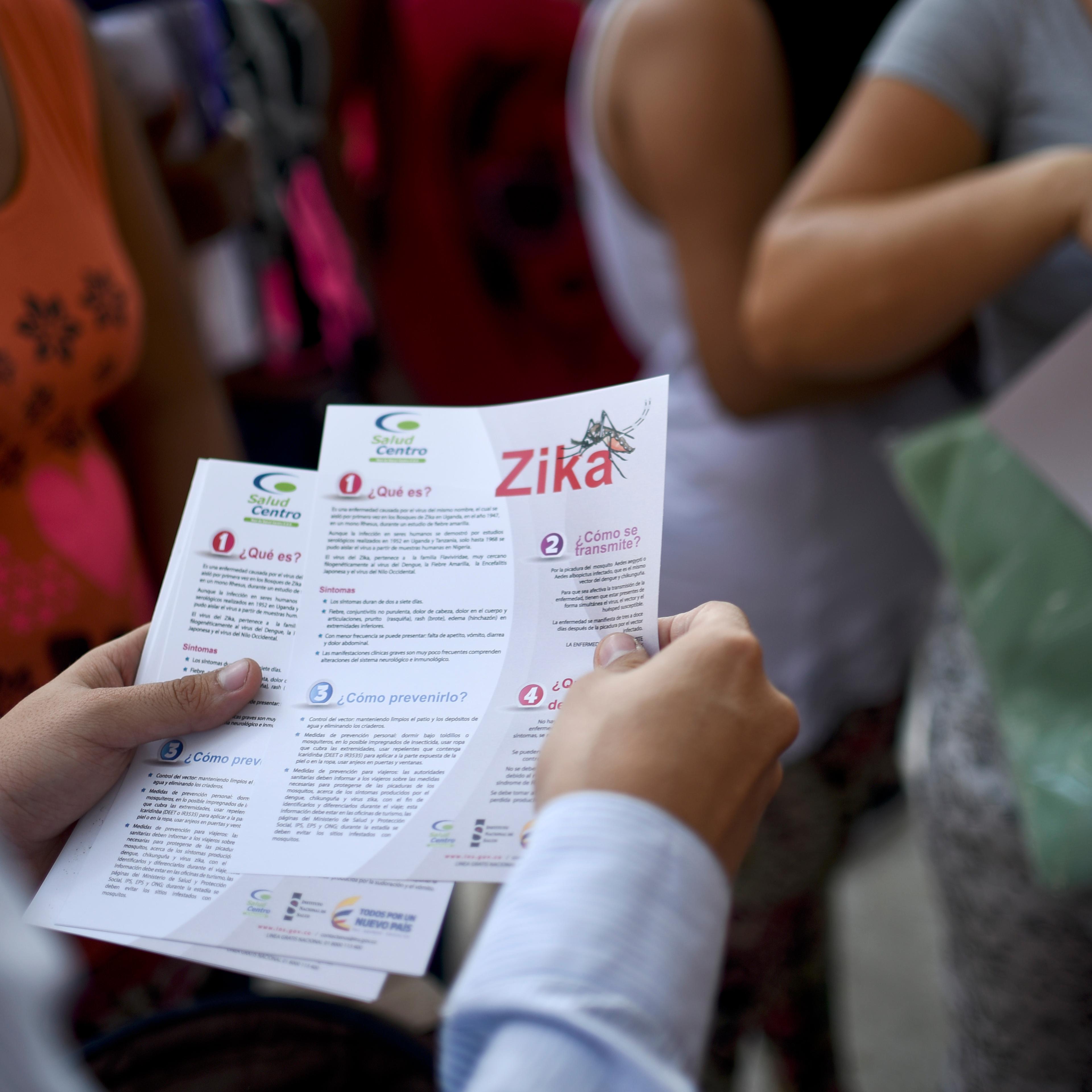 An official of the of Health Ministry delivers brochures with information about the Zika virus to pregnant women, on Feb. 10, 2016, in Cali, Colombia.