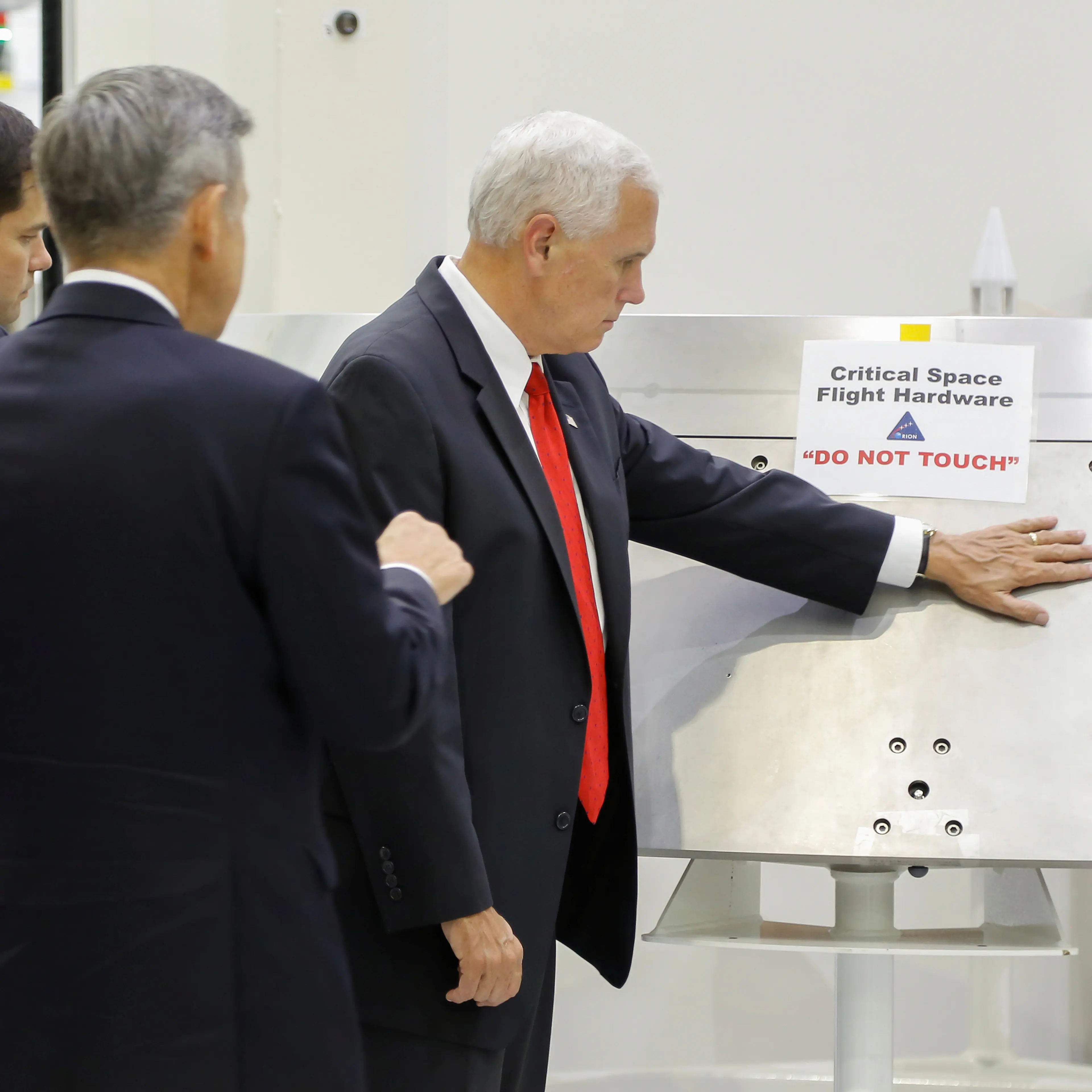 Vice President Mike Pence is shown a piece of hardware by Kennedy Space Center Director Robert Cabana during a tour of the Operations and Checkout Building in Florida, July 6, 2017.