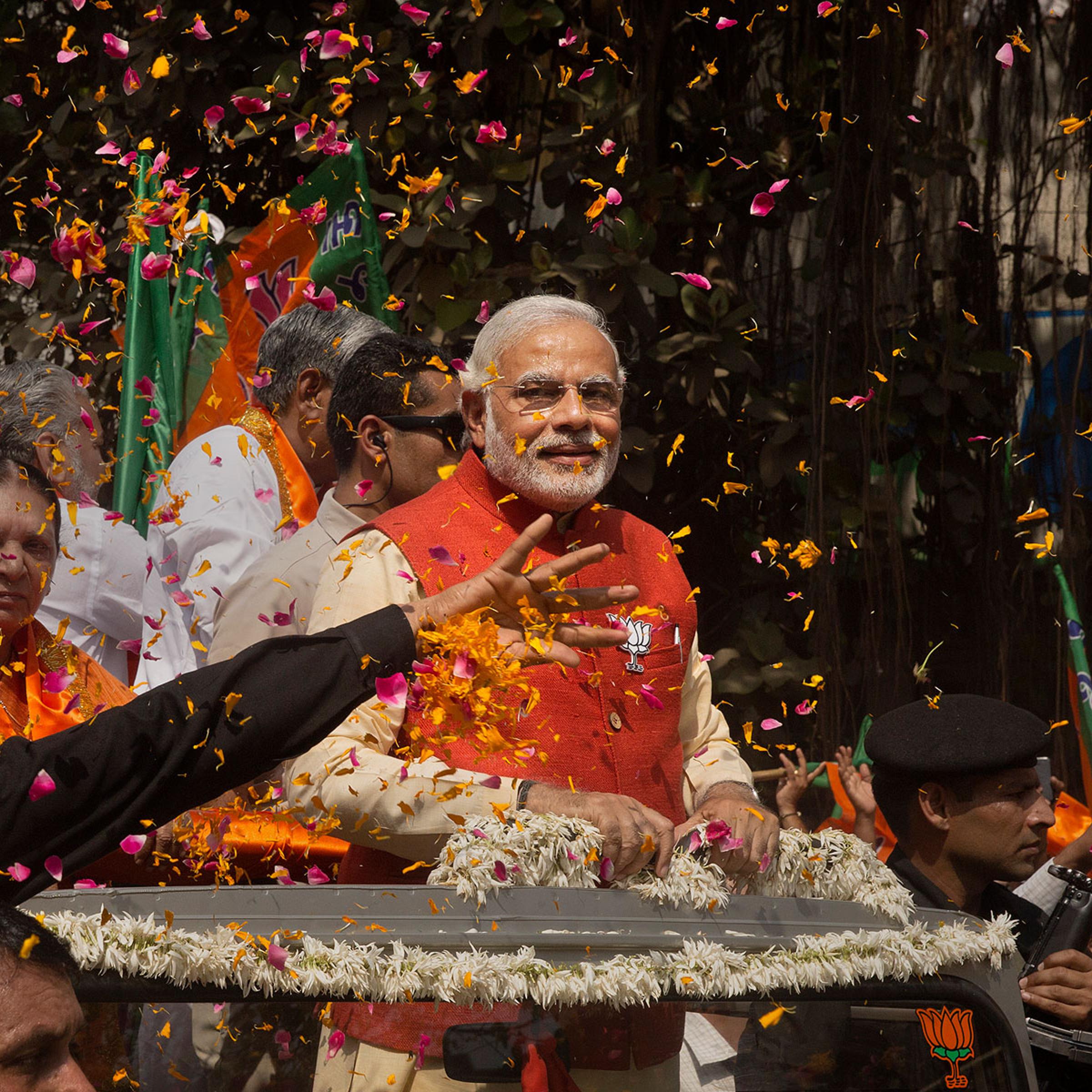 Bharatiya Janata Party leader Narendra Modi rides in an open jeep on his way to file nomination papers on April 9, 2014 in Vadodra, India