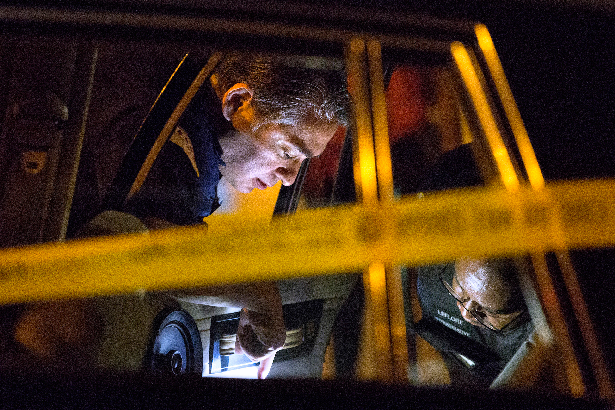 Members of the Chicago Police Department search a vehicle involved in a shooting in the 3300 block of West Douglas Boulevard parked outside of Mount Sinai Hospital Tuesday, Sept. 6, 2016, in Chicago. Two males were shot and drove themselves to the hospit