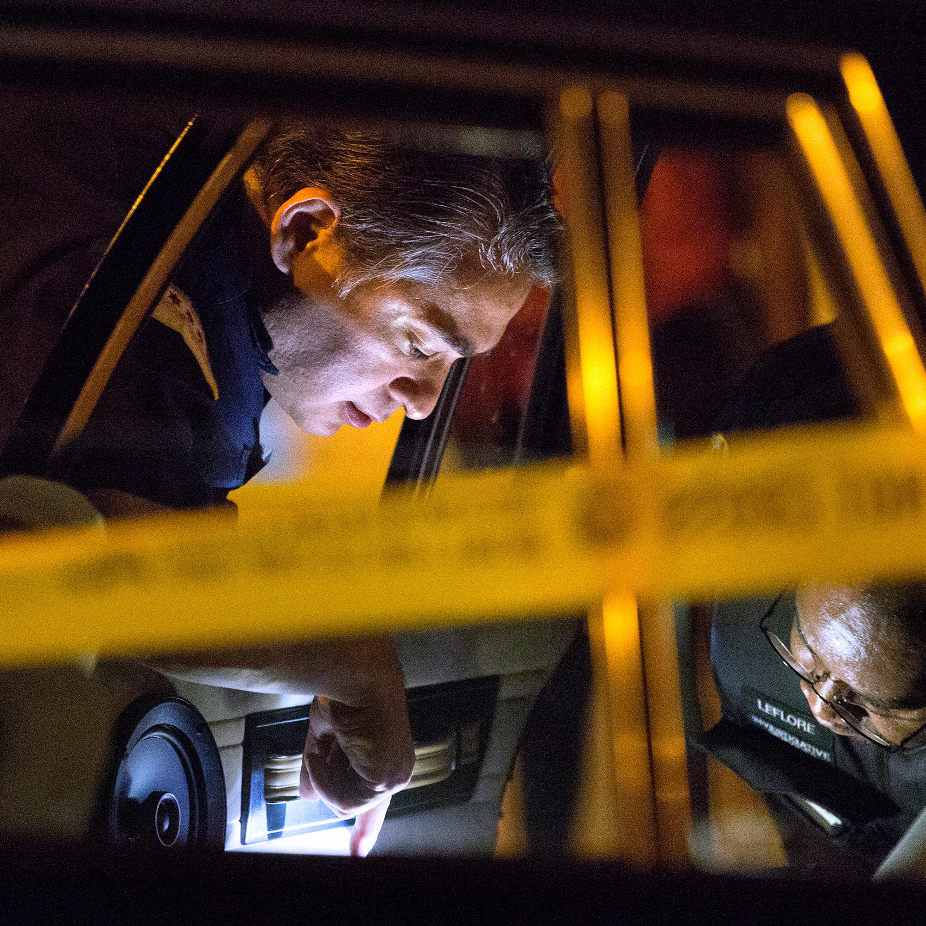 Members of the Chicago Police Department search a vehicle involved in a shooting in the 3300 block of West Douglas Boulevard parked outside of Mount Sinai Hospital Tuesday, Sept. 6, 2016, in Chicago. Two males were shot and drove themselves to the hospit