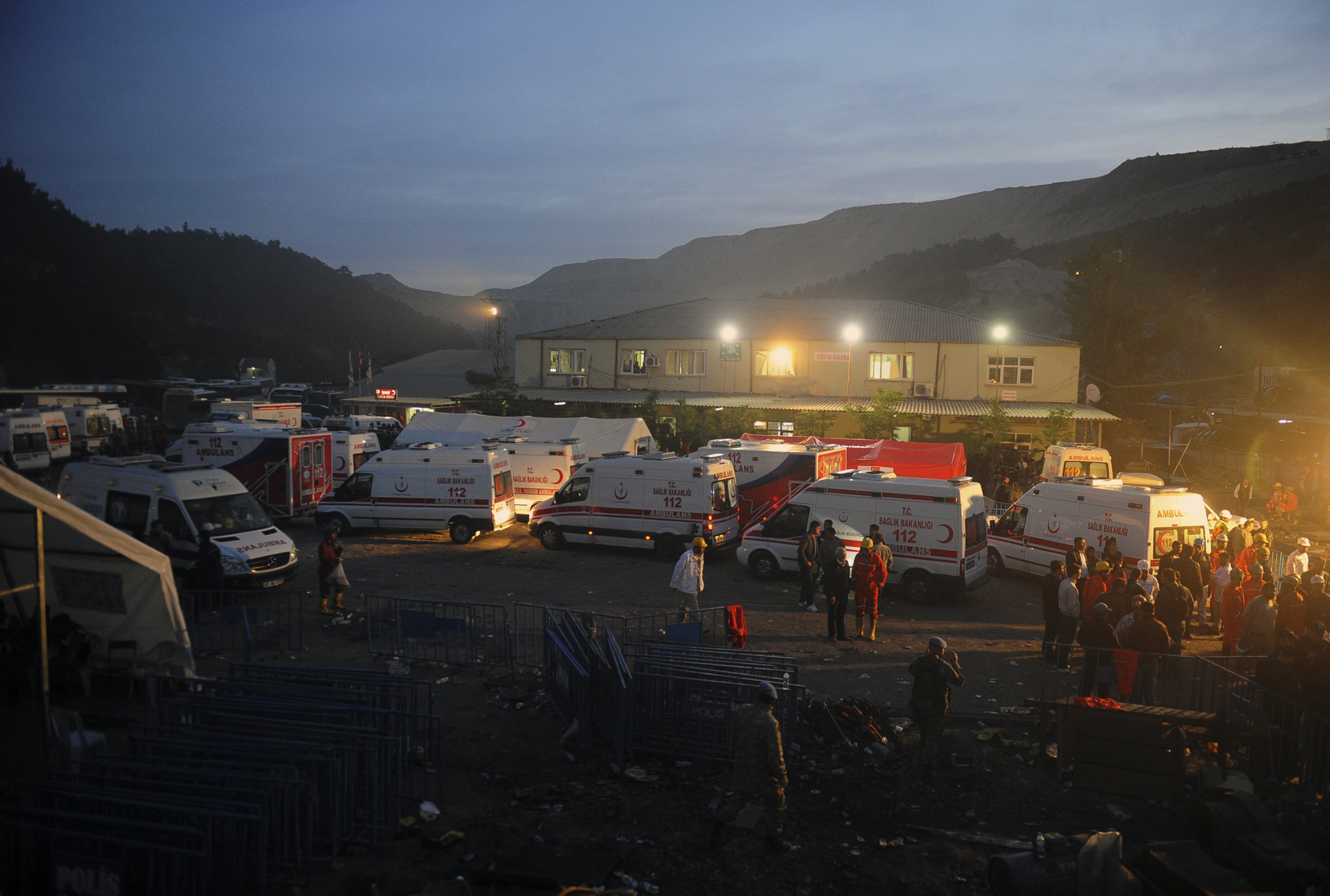 Family members and miners gather around ambulances waiting outside a coal mine in Soma, western Turkey, early Wednesday, May 14, 2014.