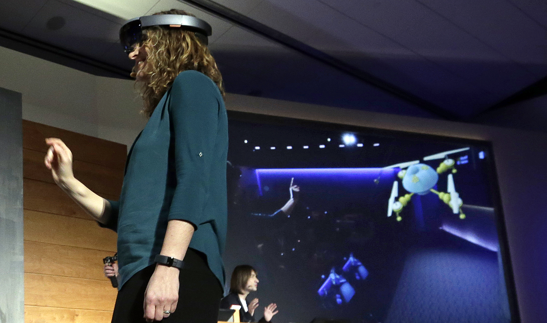 Microsoft's Lorraine Bardeen demonstrates the new Microsoft HoloLens headset in Redmond, Wash. on Jan. 21, 2015.