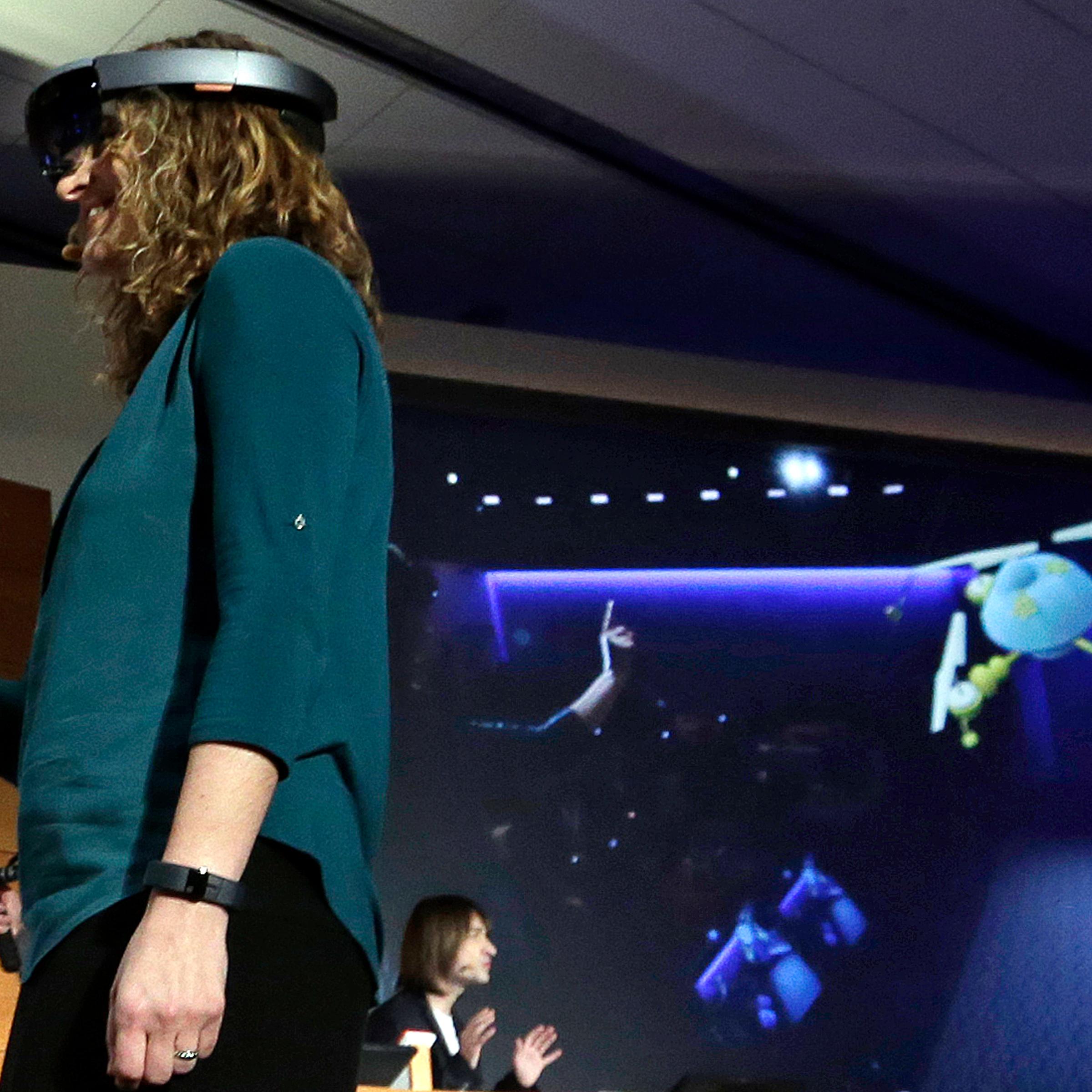 Microsoft's Lorraine Bardeen demonstrates the new Microsoft HoloLens headset in Redmond, Wash. on Jan. 21, 2015.