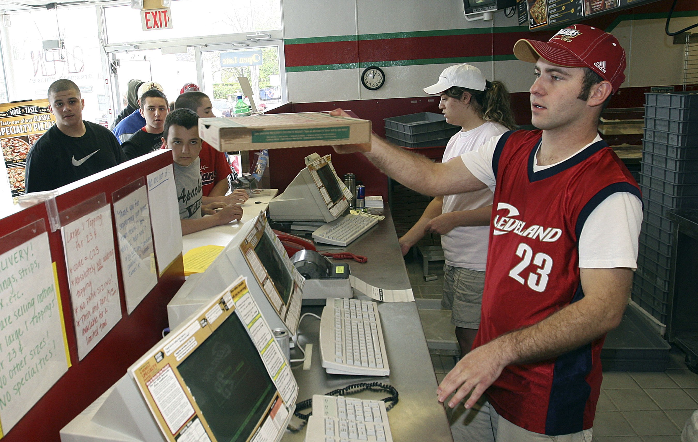 Papa Johns worker hands out pizzas in response to Washington D.C. Papa Johns promotion in which Cavaliers James was shown on shirts as cry baby in Lakewood