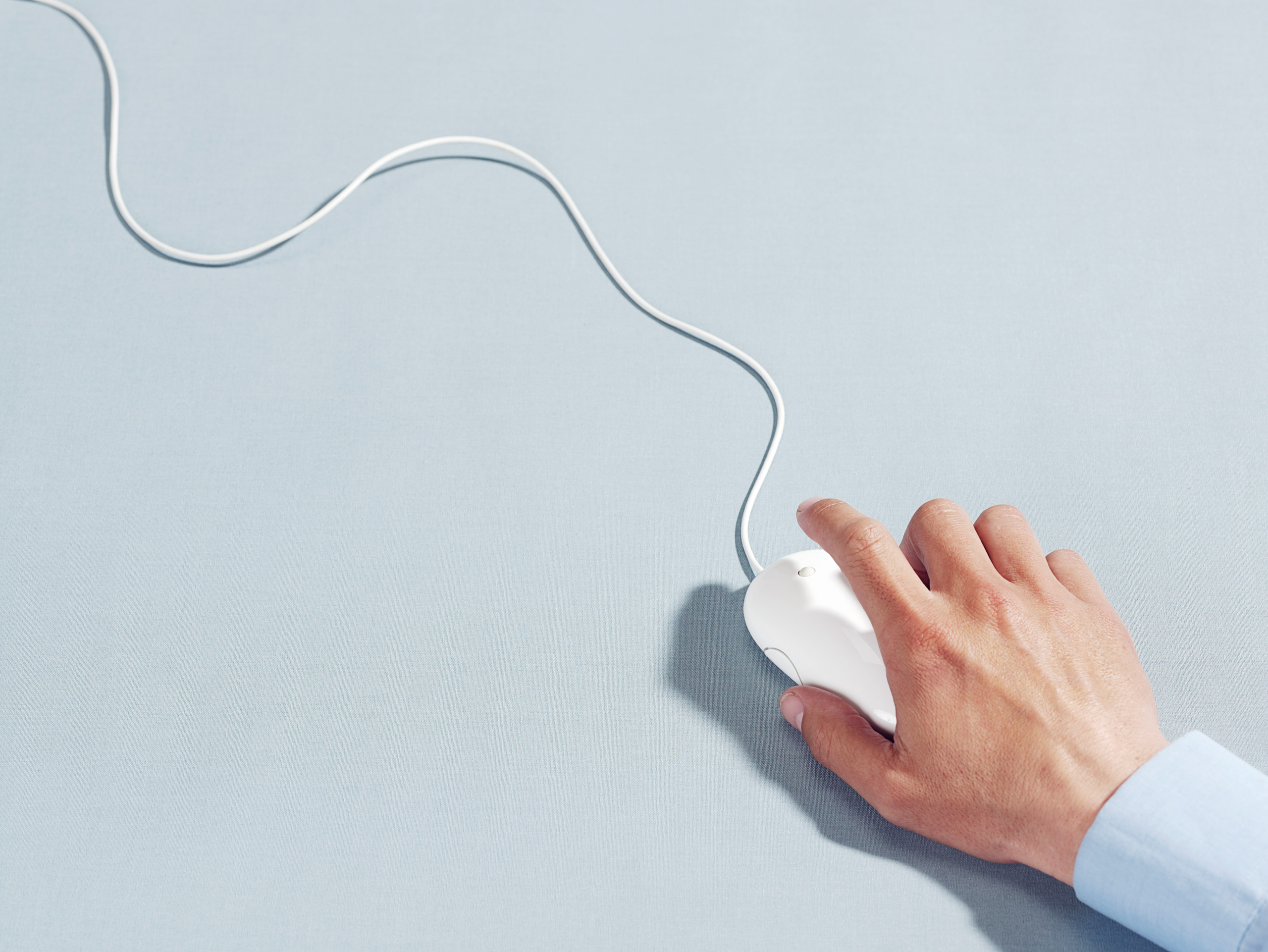 Man using computer mouse, close-up of hand