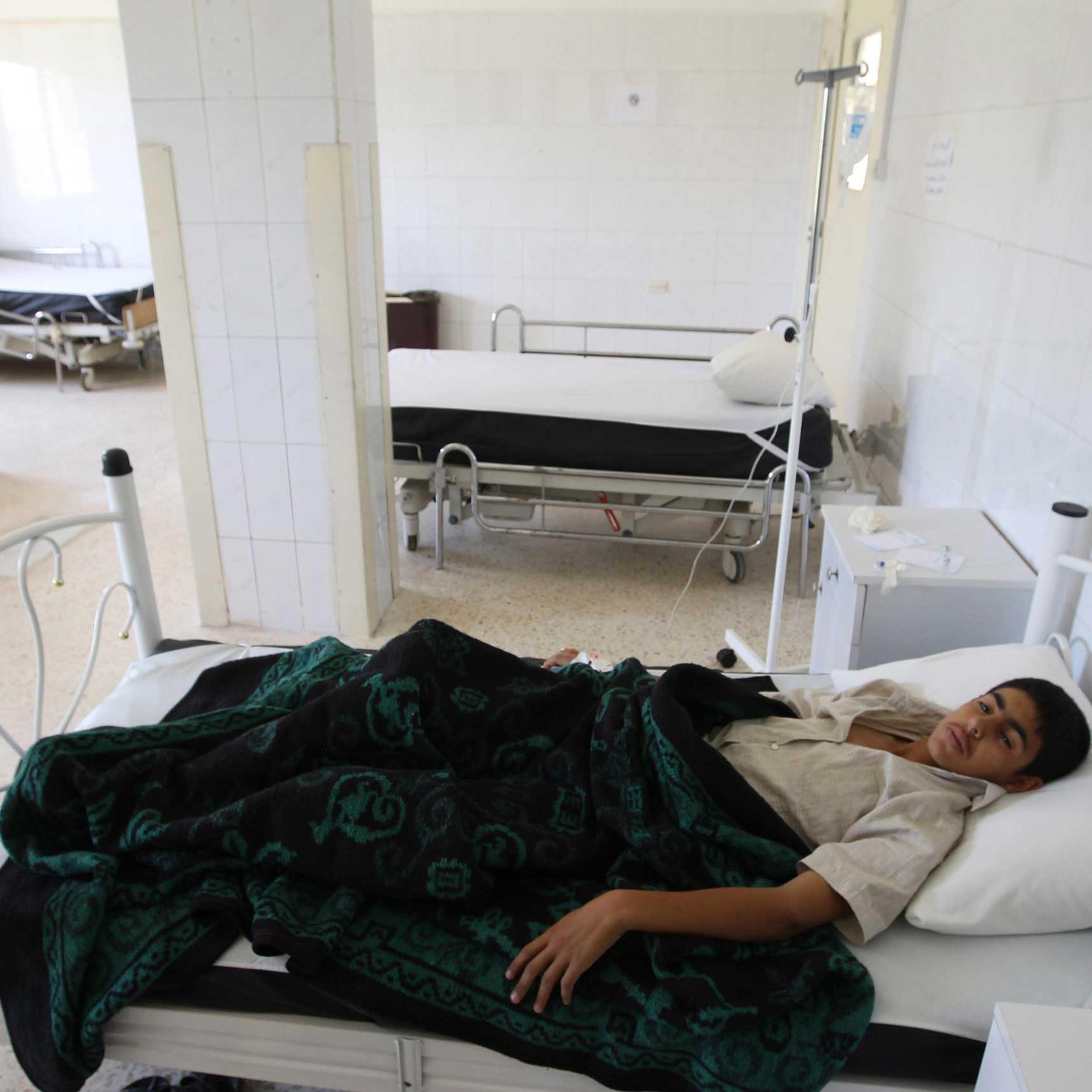A boy infected by typhoid from polluted water, lies at a hospital in al-Qouniya village in Idlib, Syria, May 27, 2013.