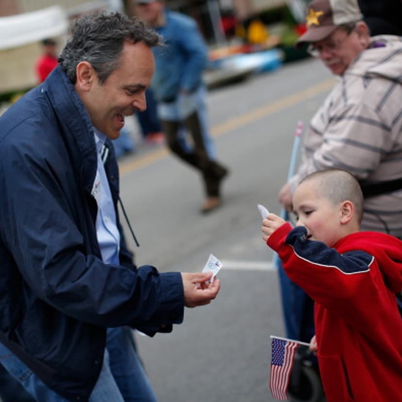 Kentucky Republican senatorial candidate Matt Bevin greets a child at the Fountain Run BBQ Festival while campaigning for the Republican primary May 17, 2014 in Fountain Run, Kentucky.