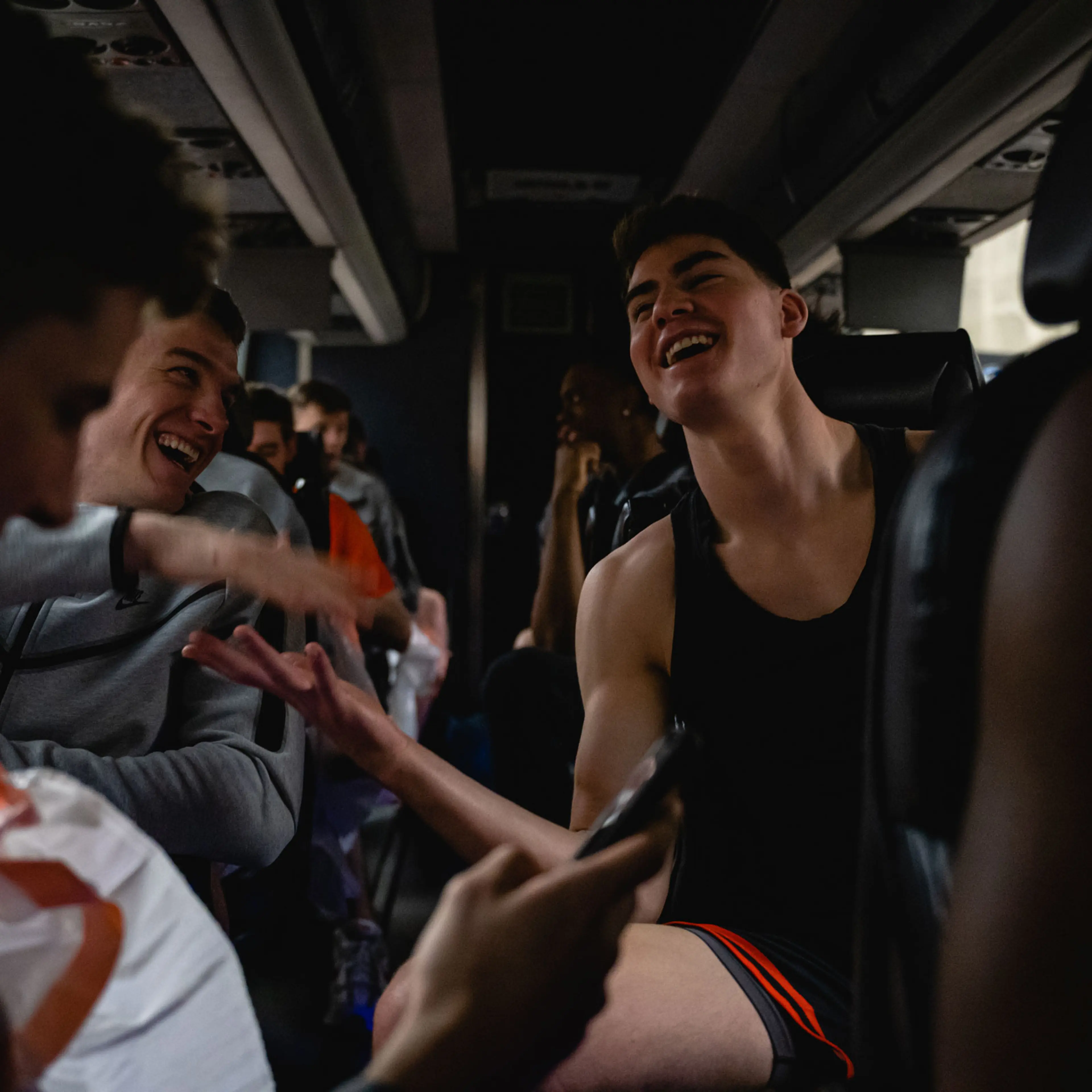 Blake Peters (L) and Jack Scott (R) laugh and embrace on the team bus on their way to the KFC YUM! Center in Louisville, Kentucky on March 23, 2023.