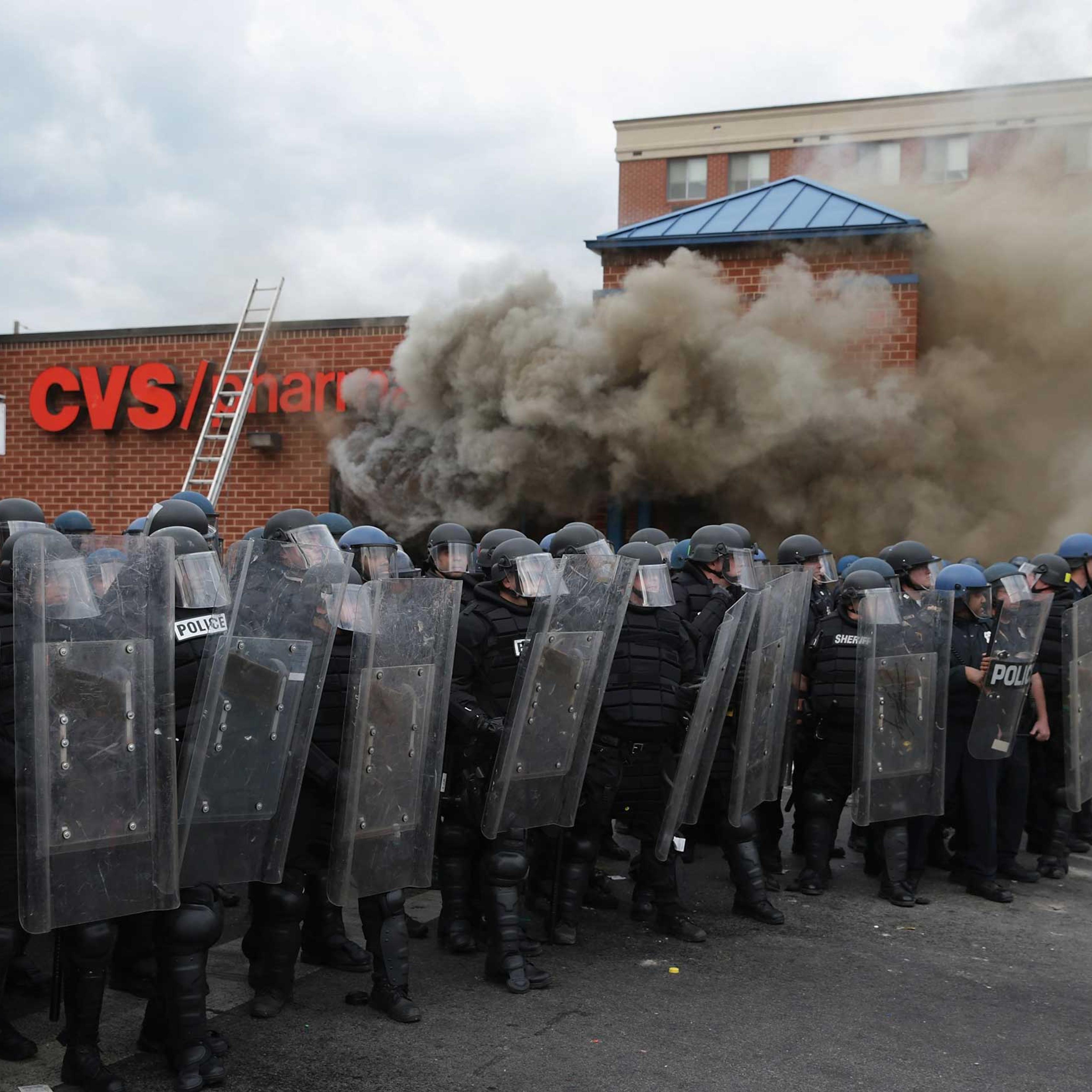 Baltimore Police form a perimeter around a CVS pharmacy that was looted and burned in Baltimore on April 27, 2015.