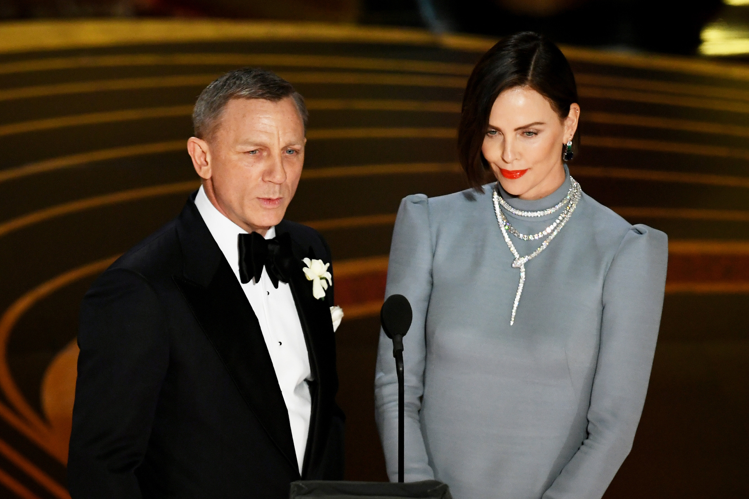Daniel Craig and Charlize Theron speak onstage during the 91st Annual Academy Awards at Dolby Theatre on Feb. 24, 2019.