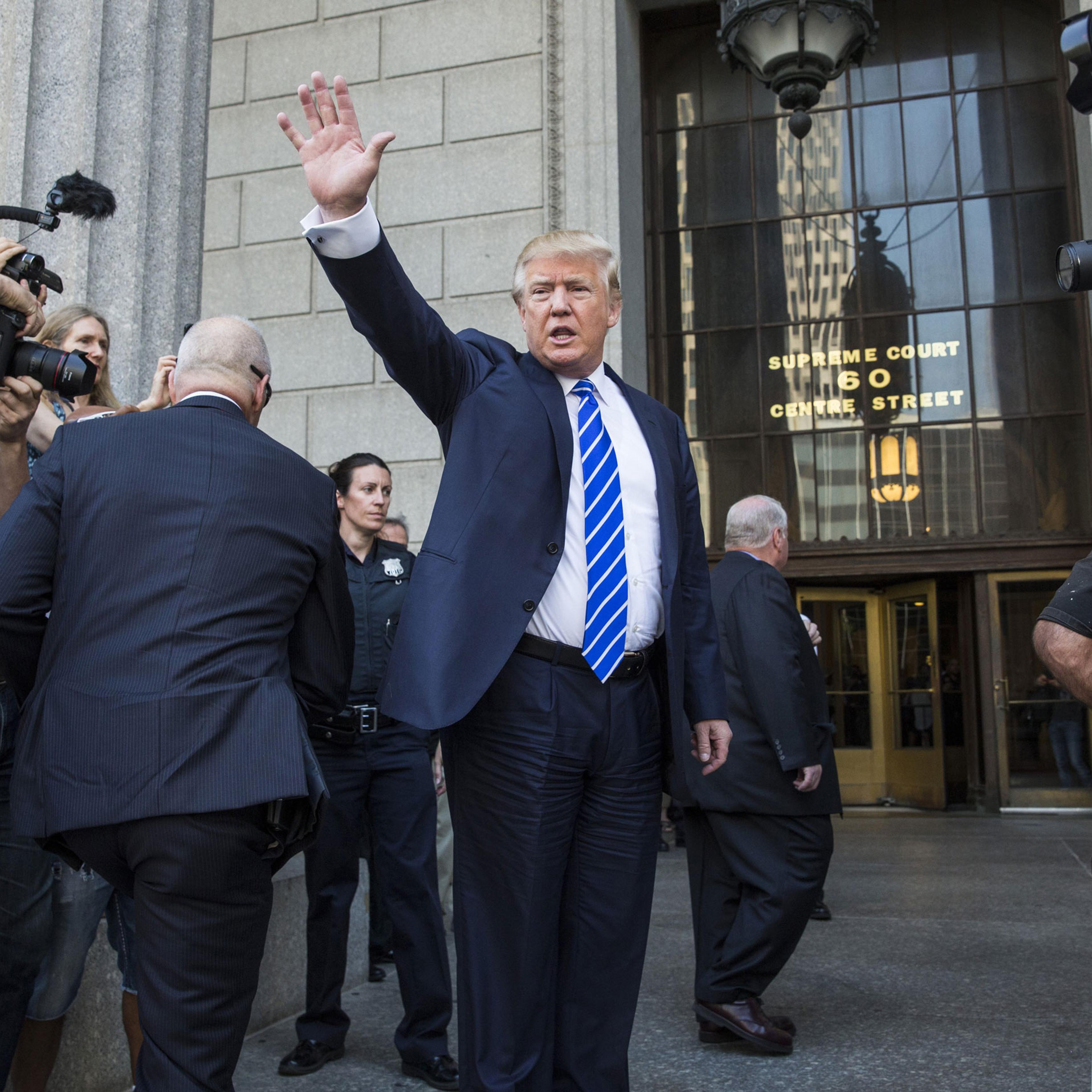 NEW YORK, NY - AUGUST 17: Republican Presidential hopeful Donald Trump waves as he arrives at U.S. Federal Court to report for jury duty on August 17, 2015 in New York City. Trump spent the last few days on the campaign trail at the Iowa state fair befor