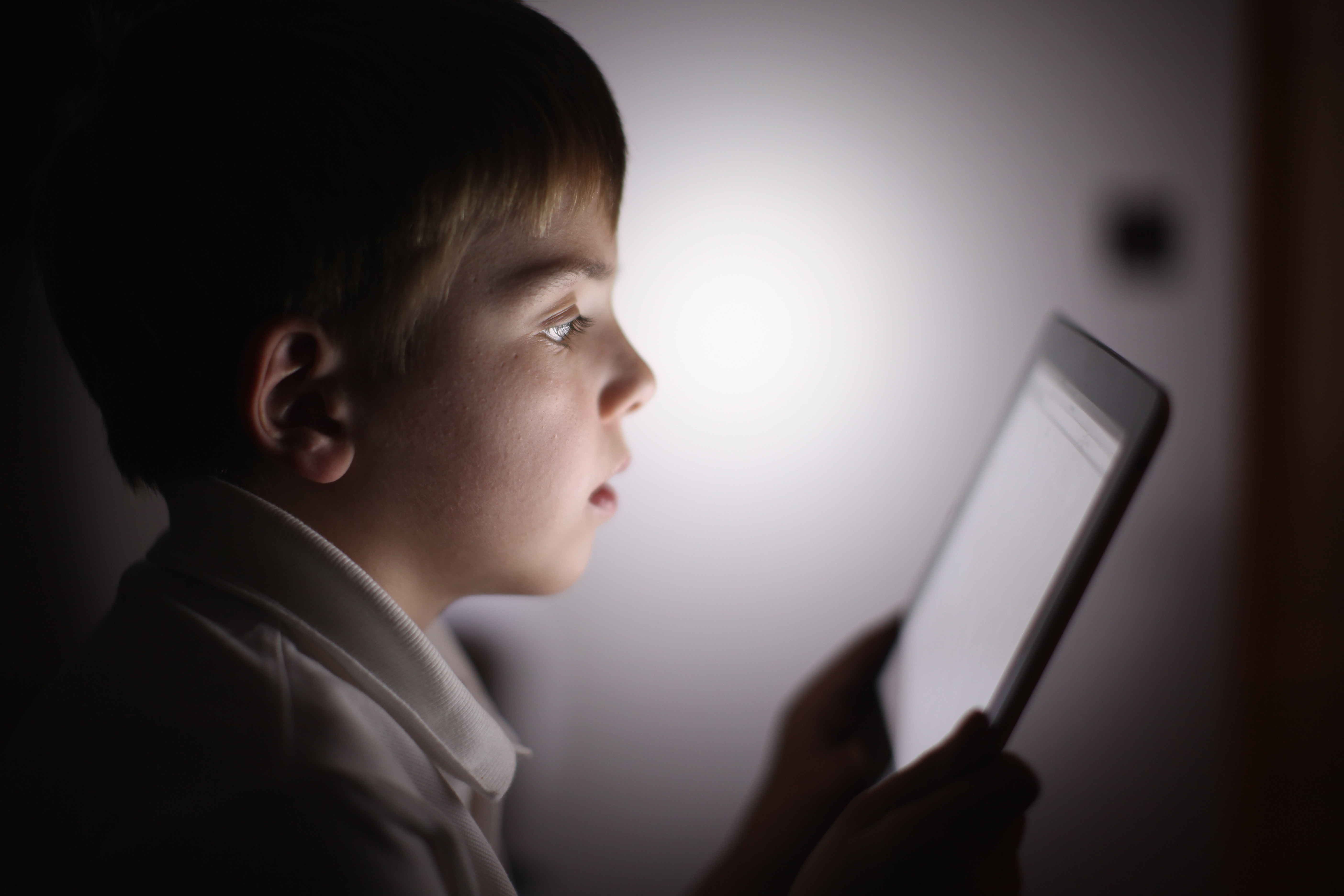 KNUTSFORD, UNITED KINGDOM - NOVEMBER 29: In this photograph illustration a ten-year-old boy uses an Apple Ipad tablet computer on November 29, 2011 in Knutsford, United Kingdom. Tablet computers have become the most wanted Christmas present for children 