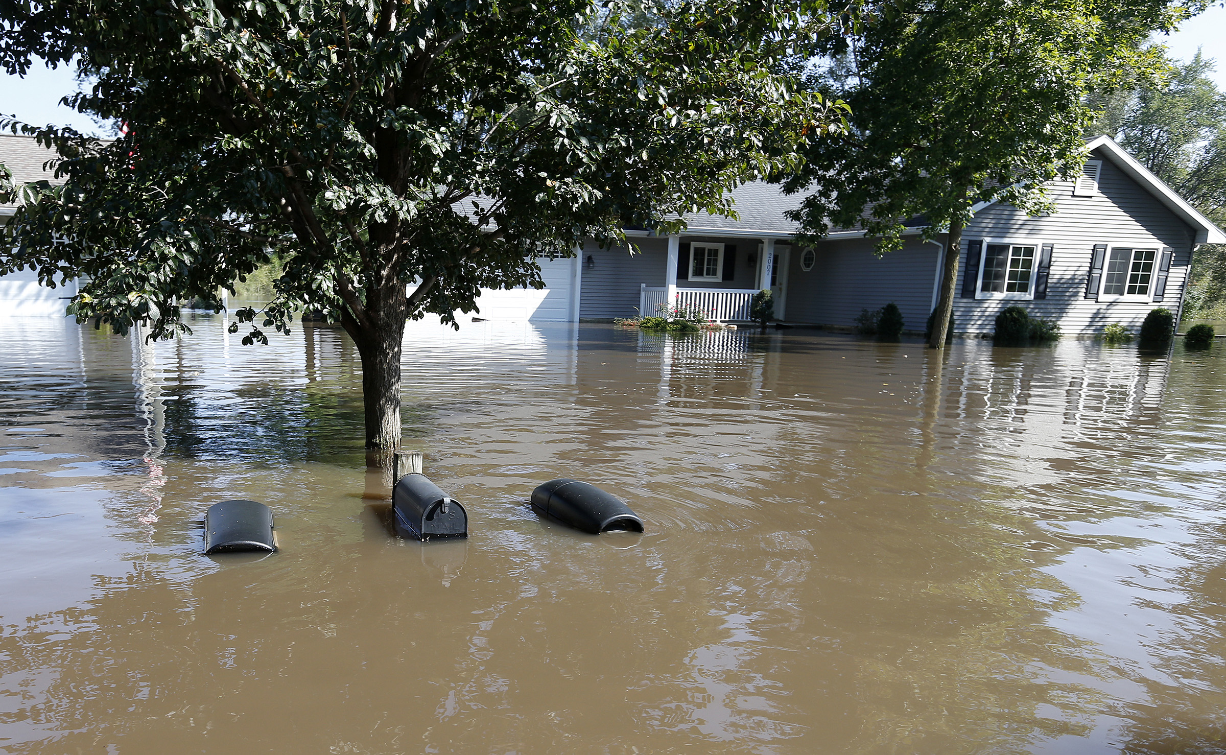 The tops of mailboxes barely break the surface of floodwaters from the Cedar River in the North Cedar neighborhood of Cedar Falls, Iowa, Sept. 24, 2016.