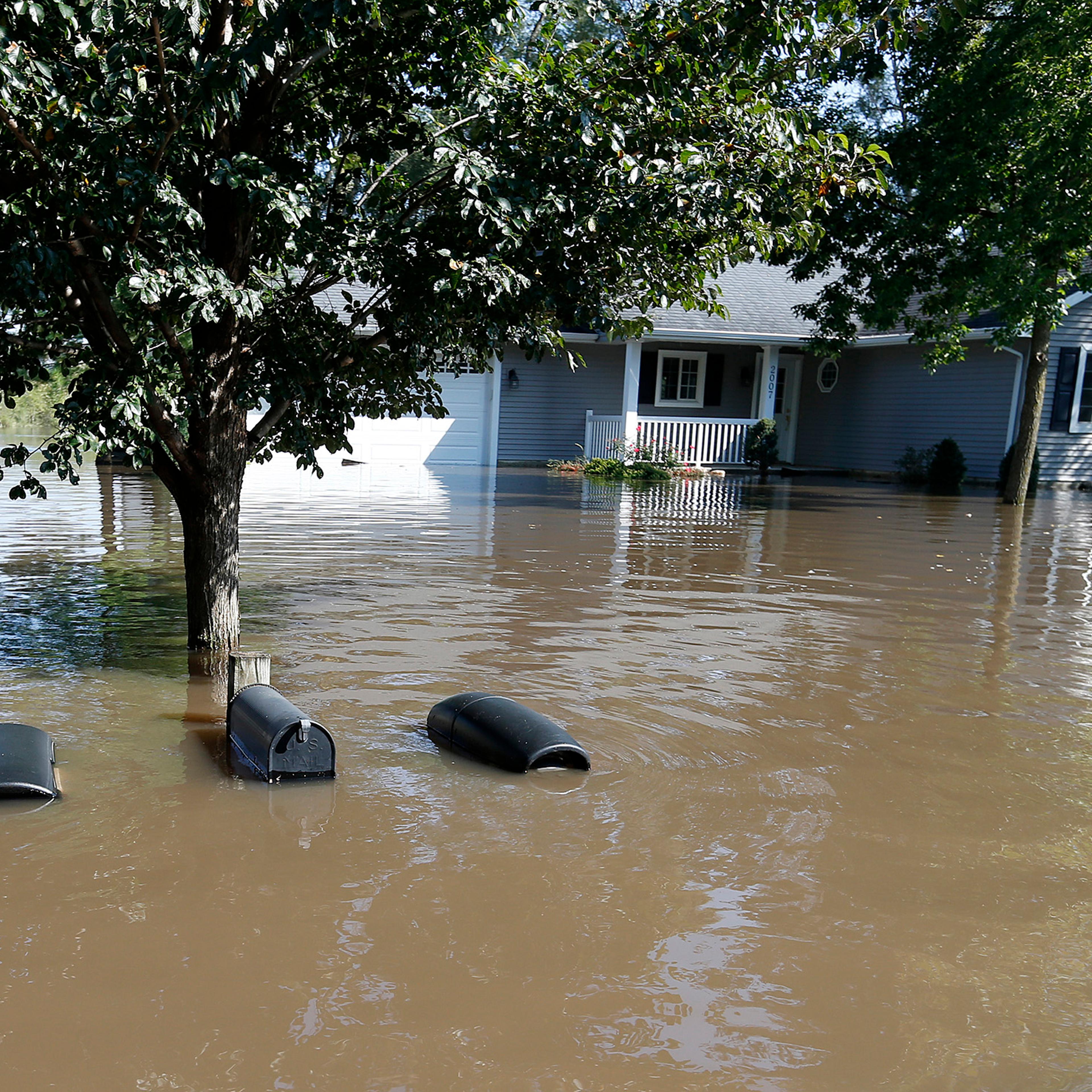 The tops of mailboxes barely break the surface of floodwaters from the Cedar River in the North Cedar neighborhood of Cedar Falls, Iowa, Sept. 24, 2016.