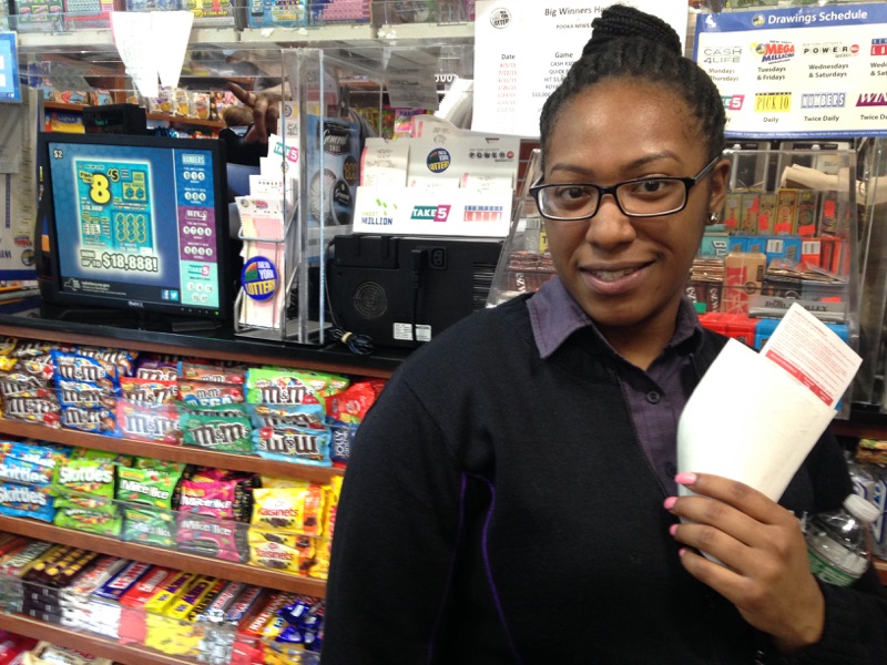 Khallinah Waiters is seen buying her first two Powerball tickets at Pooka News, near Times Square, in New York City on Jan. 12, 2015.
