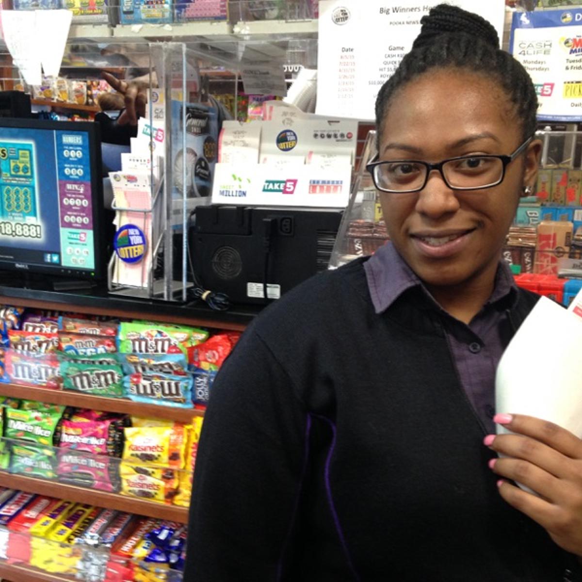 Khallinah Waiters is seen buying her first two Powerball tickets at Pooka News, near Times Square, in New York City on Jan. 12, 2015.