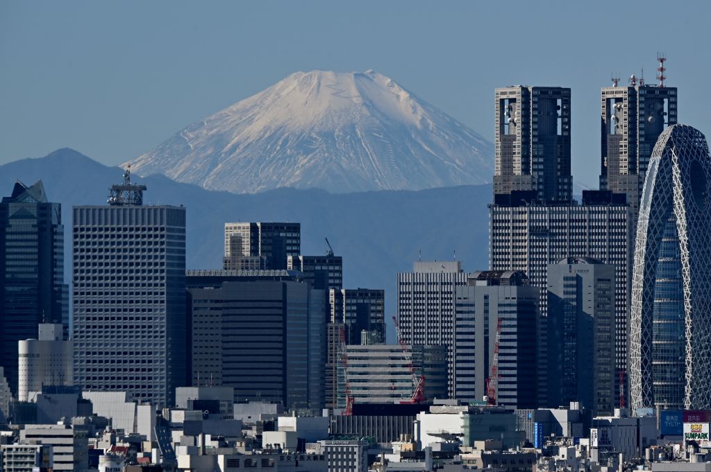 This picture taken on Nov. 14, 2023 shows Japan's highest mountain, Mt. Fuji in the background between skyscrapers in Tokyo's Shinjuku area.