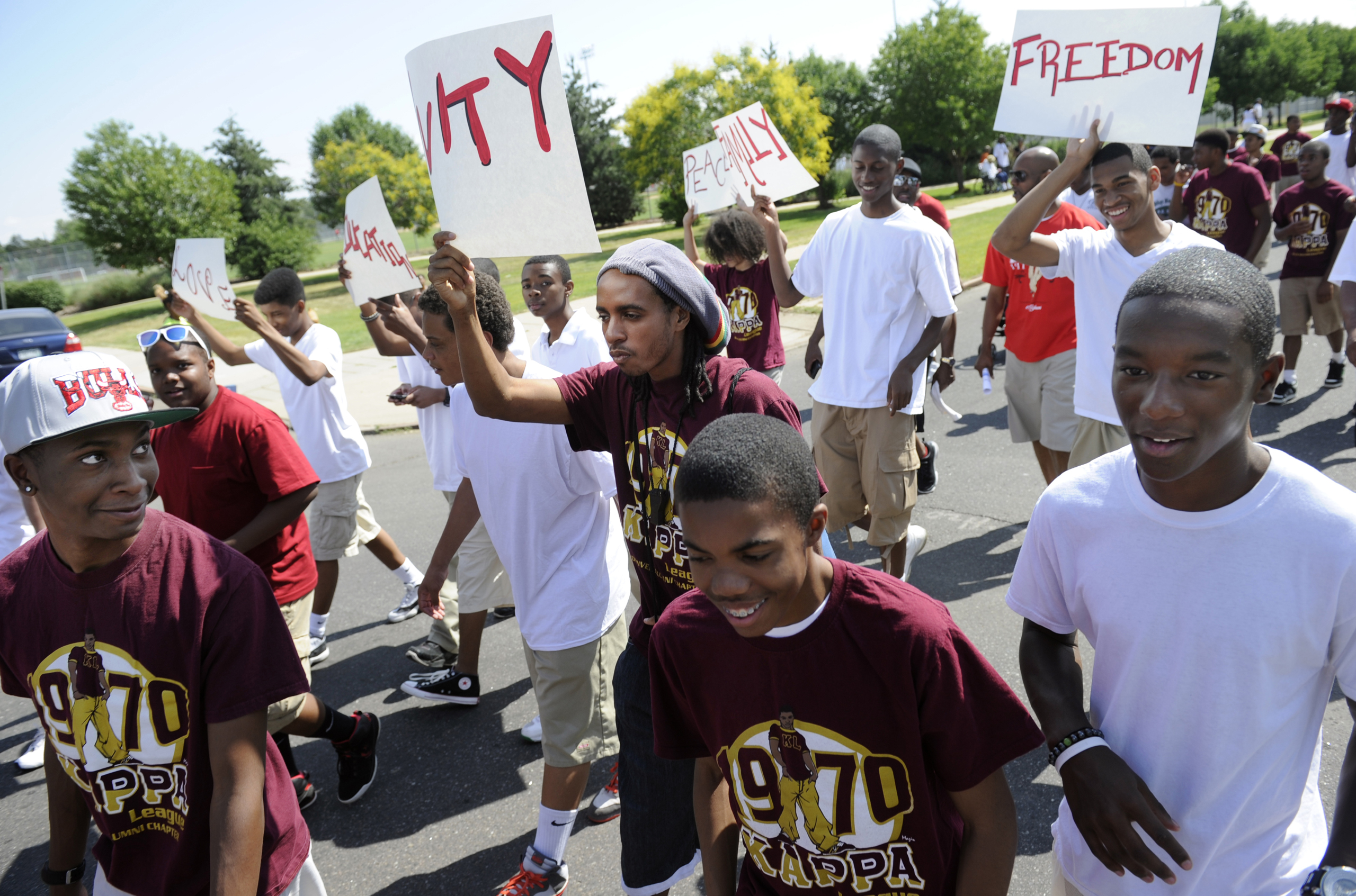 Parade participants in the Denver 2012 Juneteenth celebration leave Manual High School and march down 26th Ave. to Welton Street in the Five Points neighborhood on June 16, 2012.
