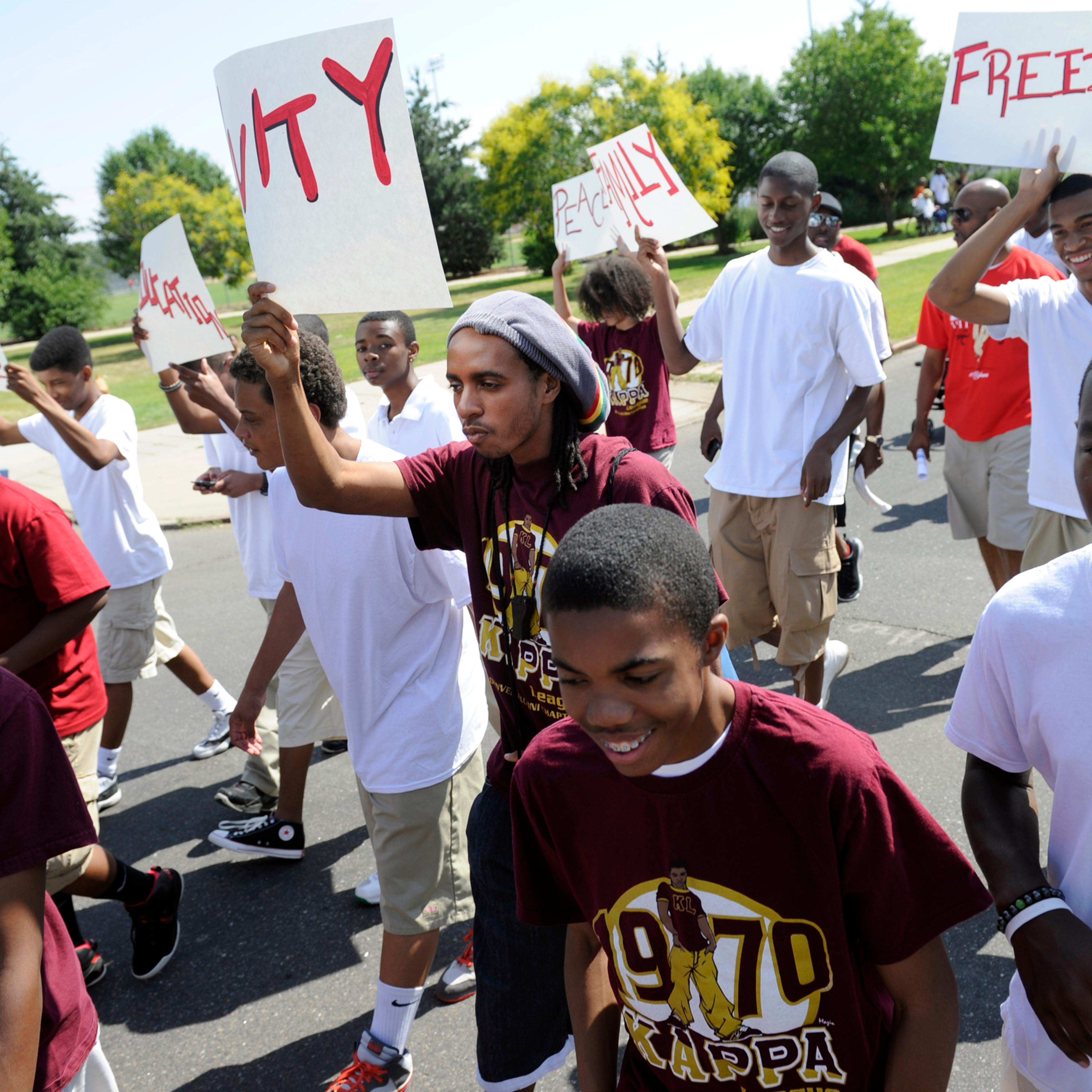 Parade participants in the Denver 2012 Juneteenth celebration leave Manual High School and march down 26th Ave. to Welton Street in the Five Points neighborhood on June 16, 2012.