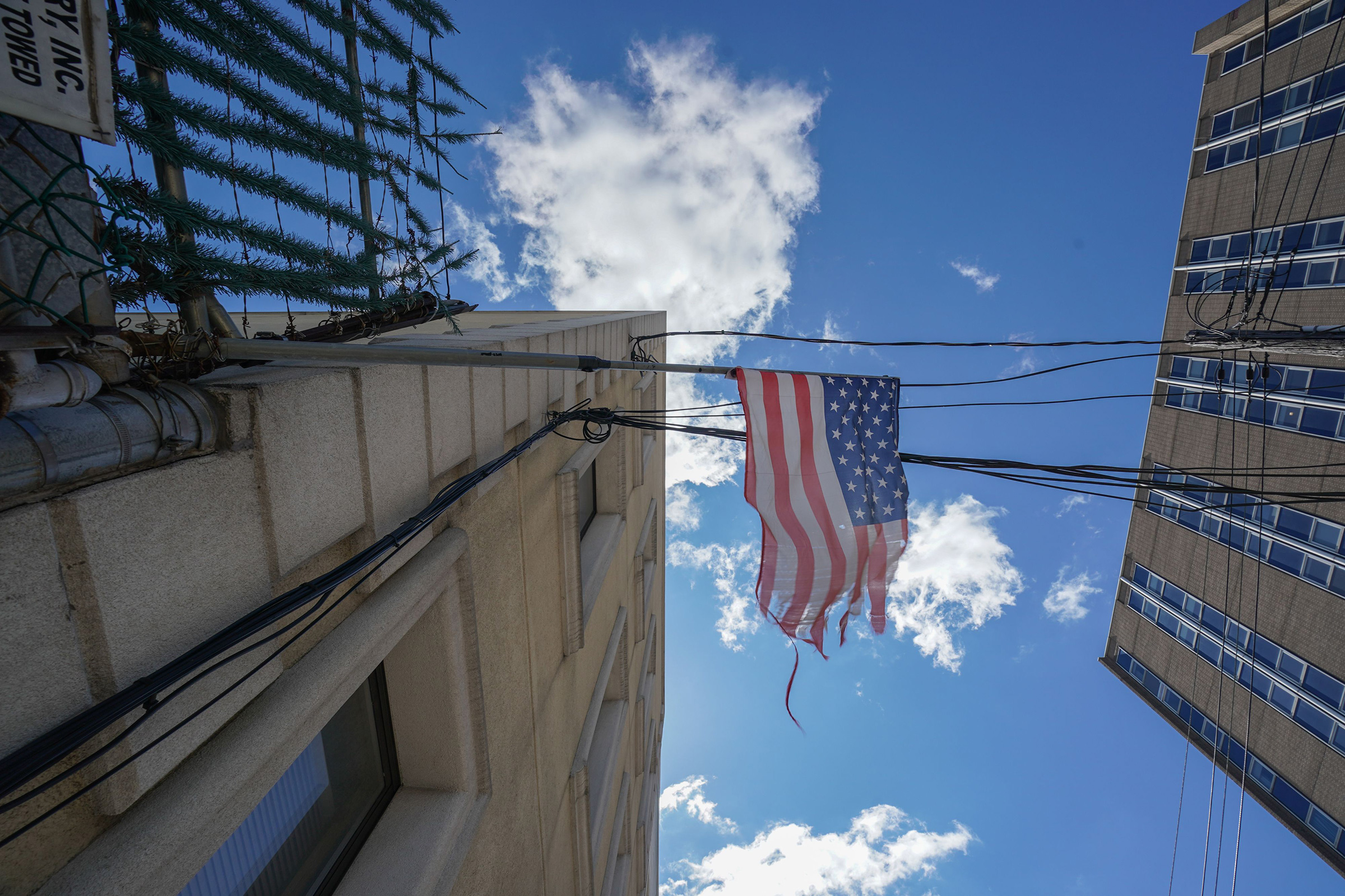 A tattered American flag hangs from a fence across the street from Wyckoff Hospital in Brooklyn, N.Y. on April 4, 2020.