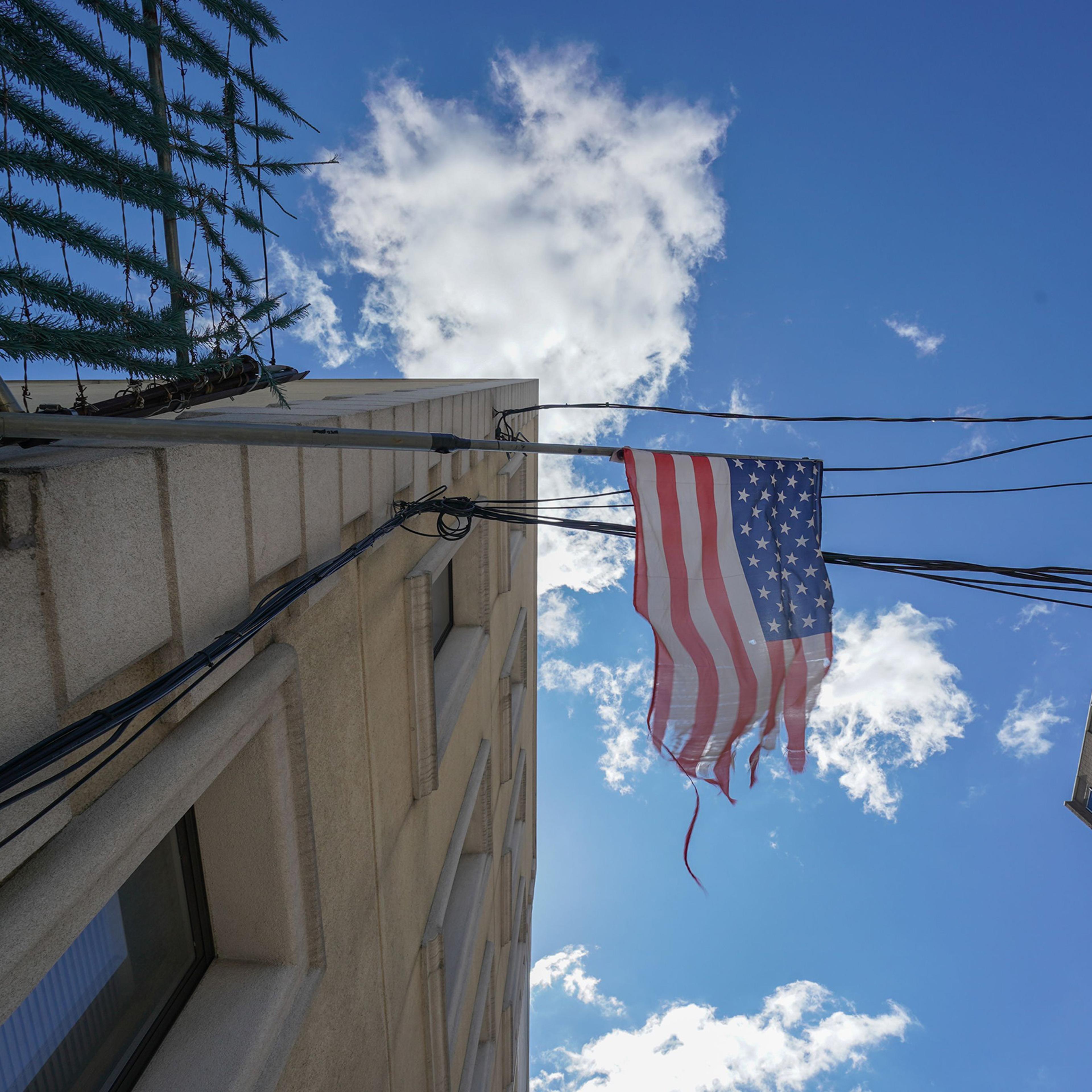 A tattered American flag hangs from a fence across the street from Wyckoff Hospital in Brooklyn, N.Y. on April 4, 2020.