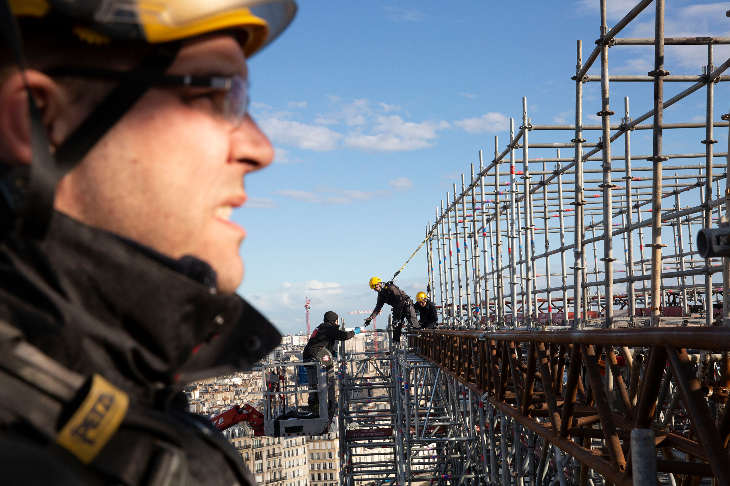 Workers atop Notre-Dame in Paris in February. Repeated delays—from high winds, inquiries into lead pollution, and now the coronavirus—have thrown that four-year time frame into doubt.