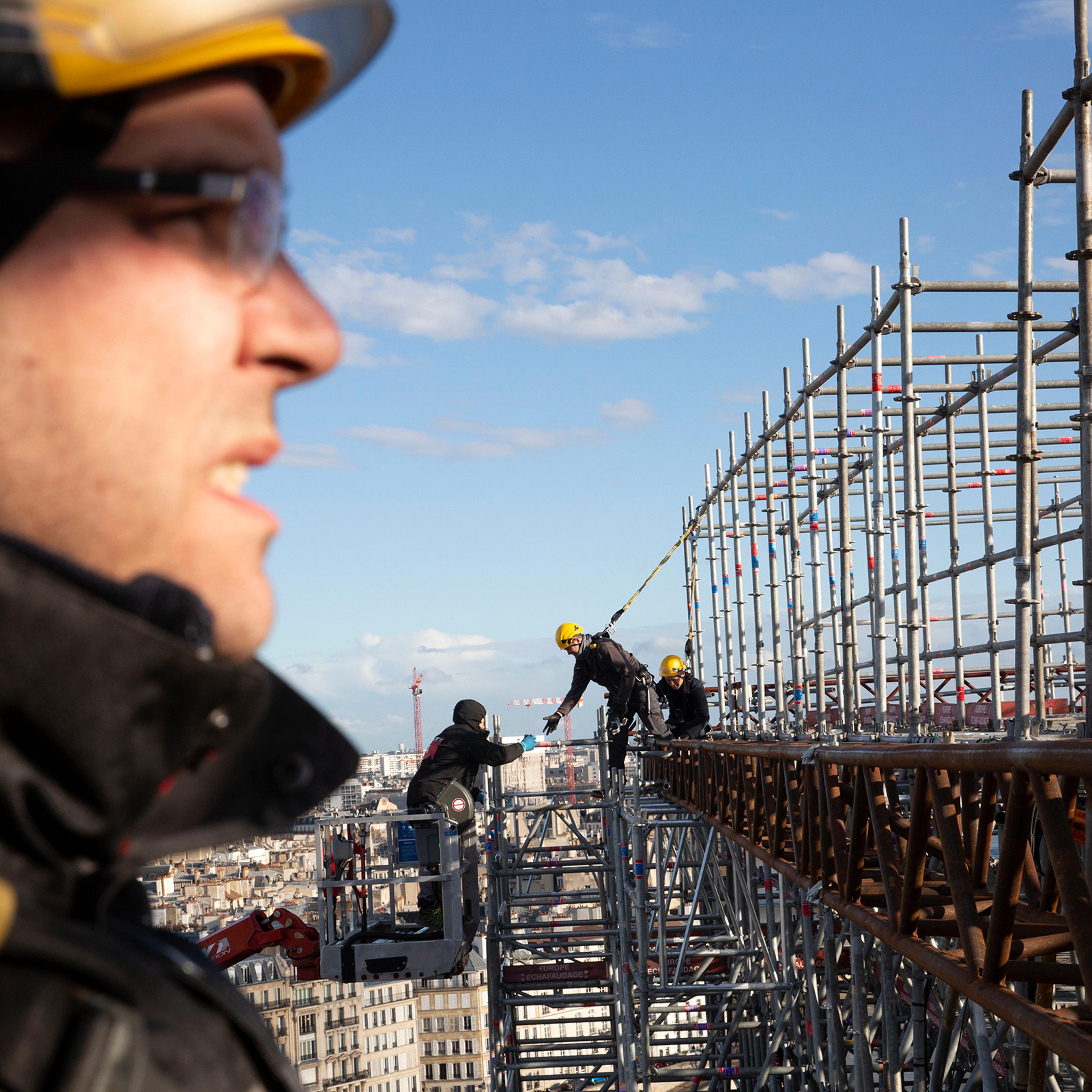 Workers atop Notre-Dame in Paris in February. Repeated delays—from high winds, inquiries into lead pollution, and now the coronavirus—have thrown that four-year time frame into doubt.