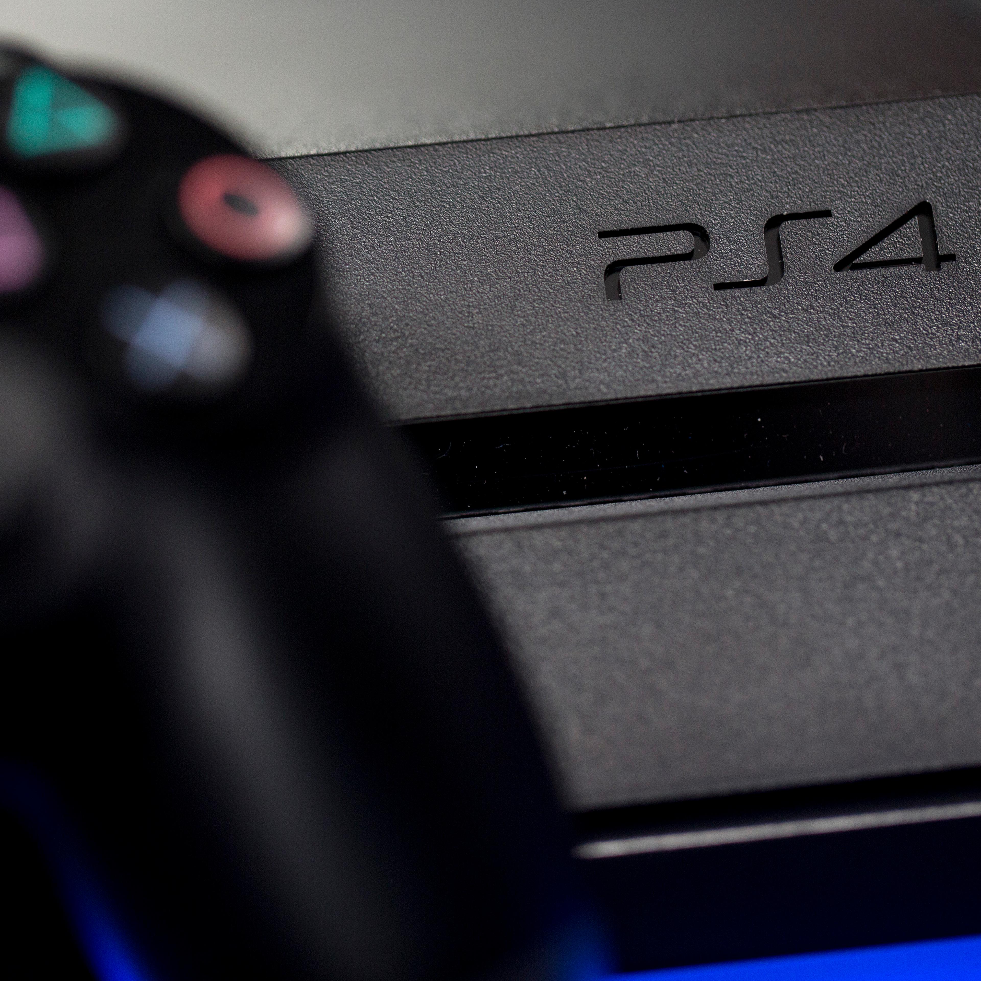 A logo sits on the front of a Sony PlayStation 4 (PS4) games console, manufactured by Sony Corp., in this arranged photograph taken in London on Nov. 15, 2013