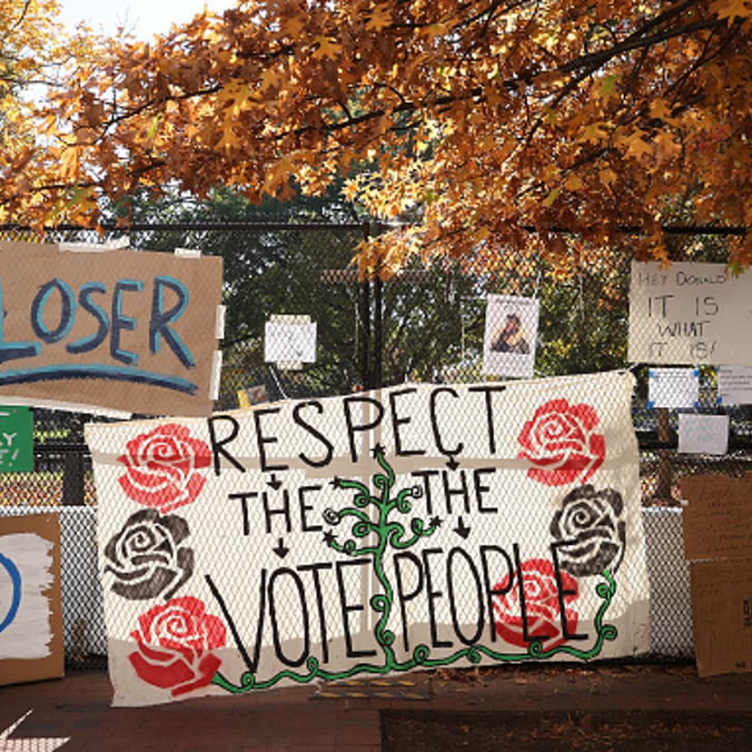 Signs critical of President Donald Trump hang on the security fence that surrounds the White House in Washington, D.C. on November 08, 2020.