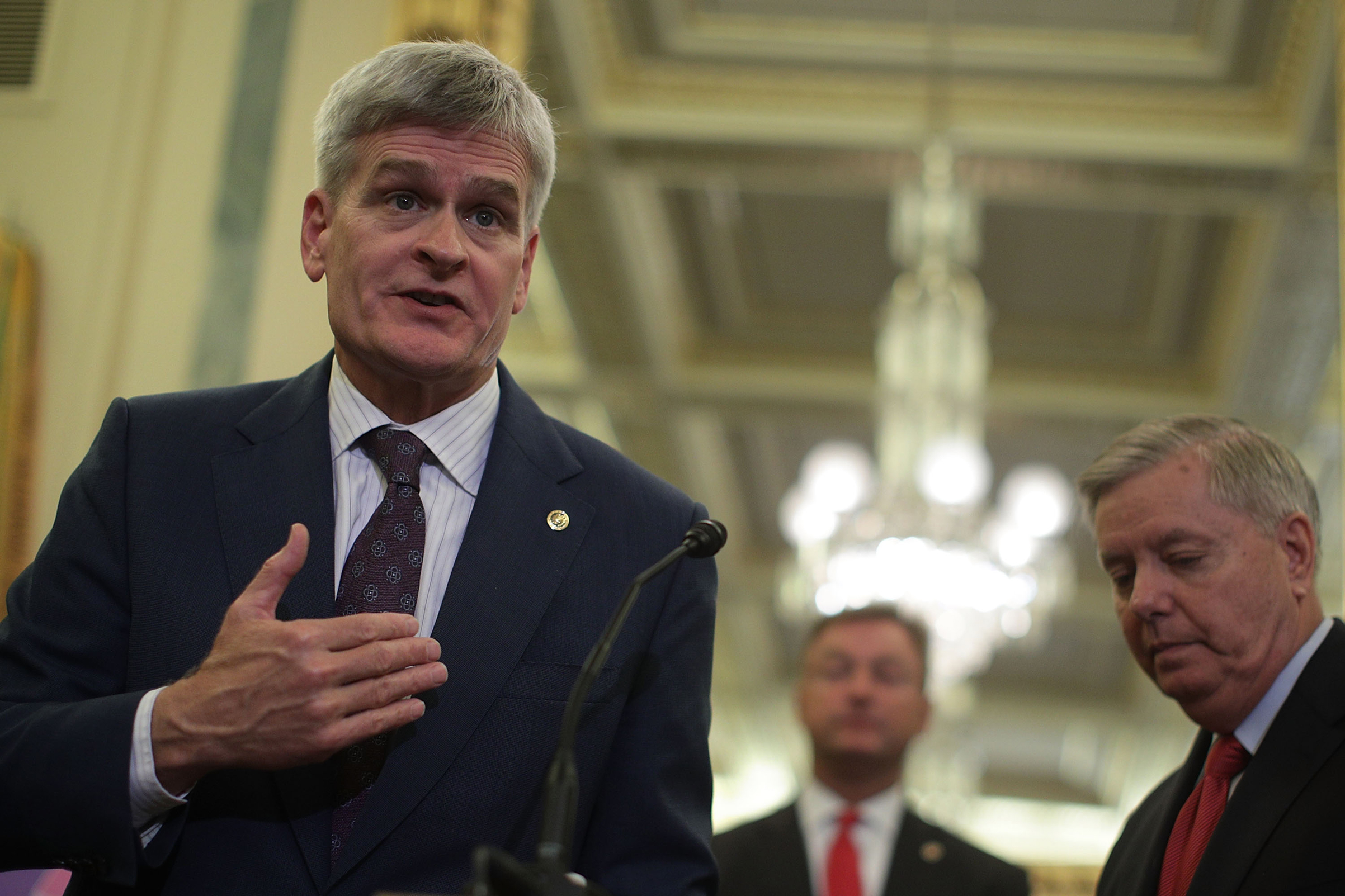 Sen. Bill Cassidy speaks as Sen. Dean Hellerand (center) and Sen. Lindsey Graham (right) listen during a news conference on health care Sept. 13, 2017 on Capitol Hill in Washington. Senators Graham, Cassidy, Heller and Johnson unveiled a proposed legisla