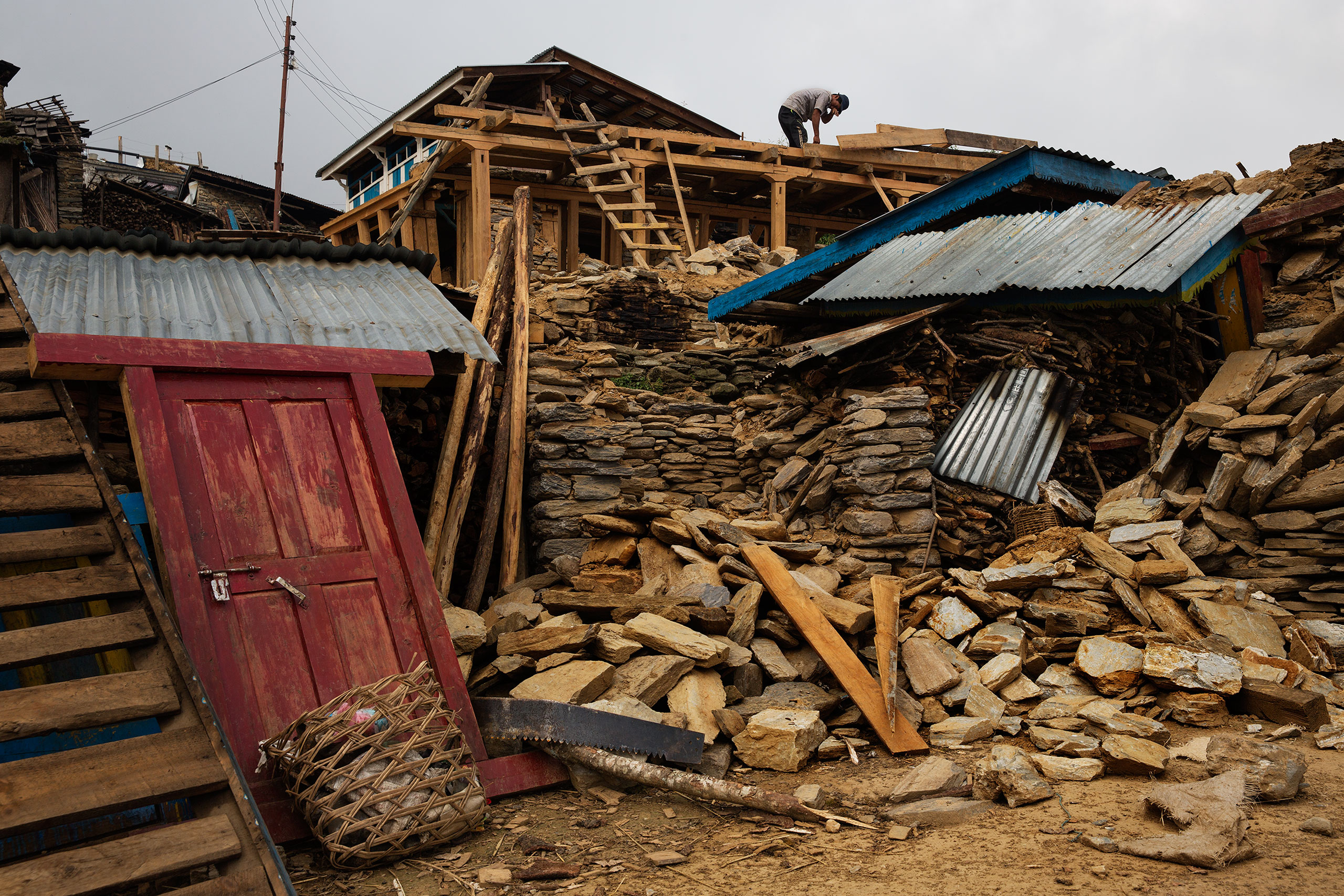 Nepal earthquake. Gumda Village, in Ghorka district. 5 people died and 14 are still missing in landslides. Inhabitants salvaging building materials from their destroyed houses. Funeral of Rejina Gurung, 3 who was just discovered buried in the rubble. Her