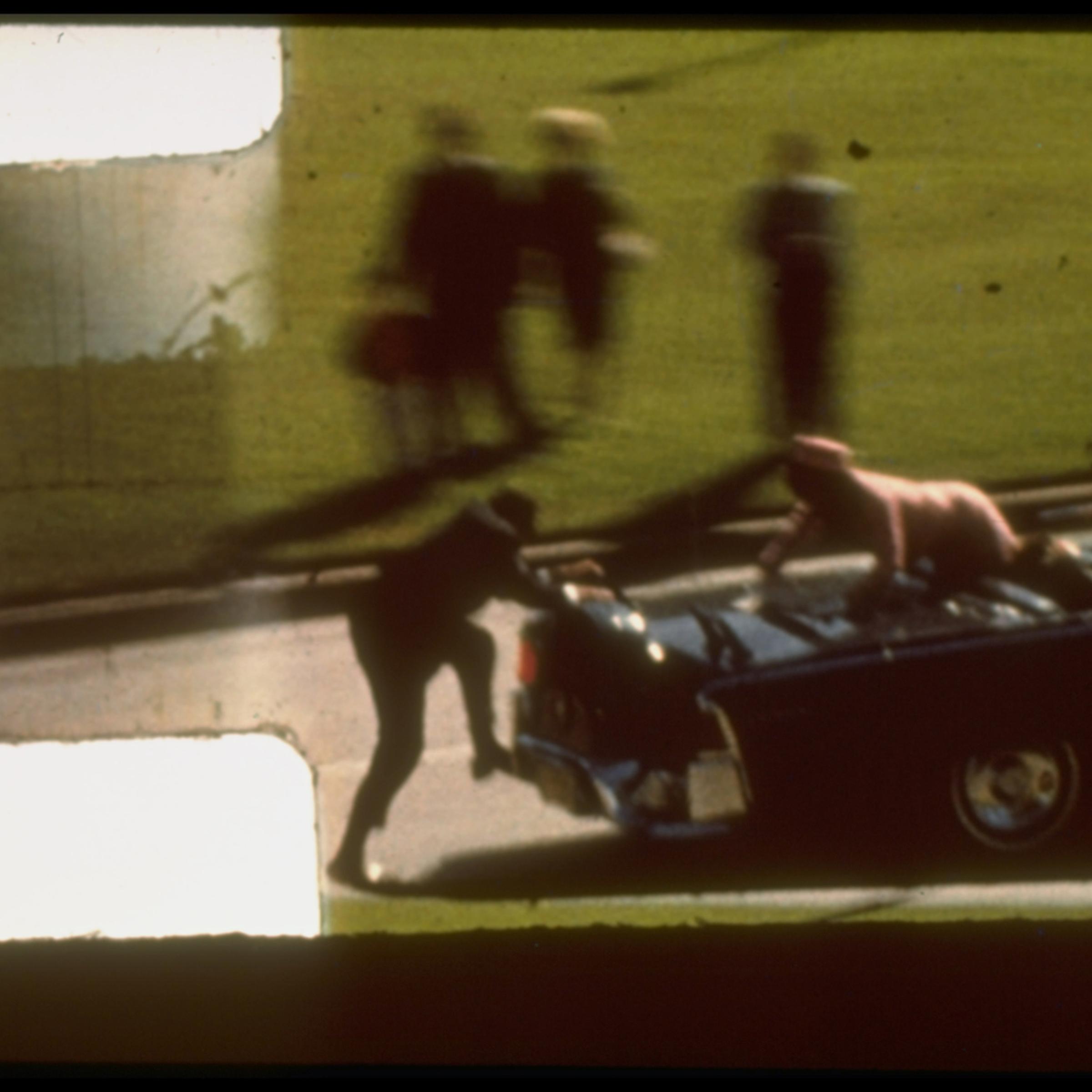 Zapruder film frame #372 of Kennedy assassination showing Mrs. Kennedy climbing towards Secret Service agent who is attempting to board back of limousine after Pres. Kennedy has been shot. Dallas. United States. Nov. 22, 1963.